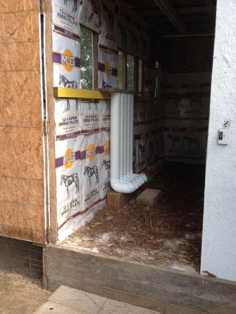 inside my hen house.... showing feed-sack wallpaper decor, and PVC pipe feeders