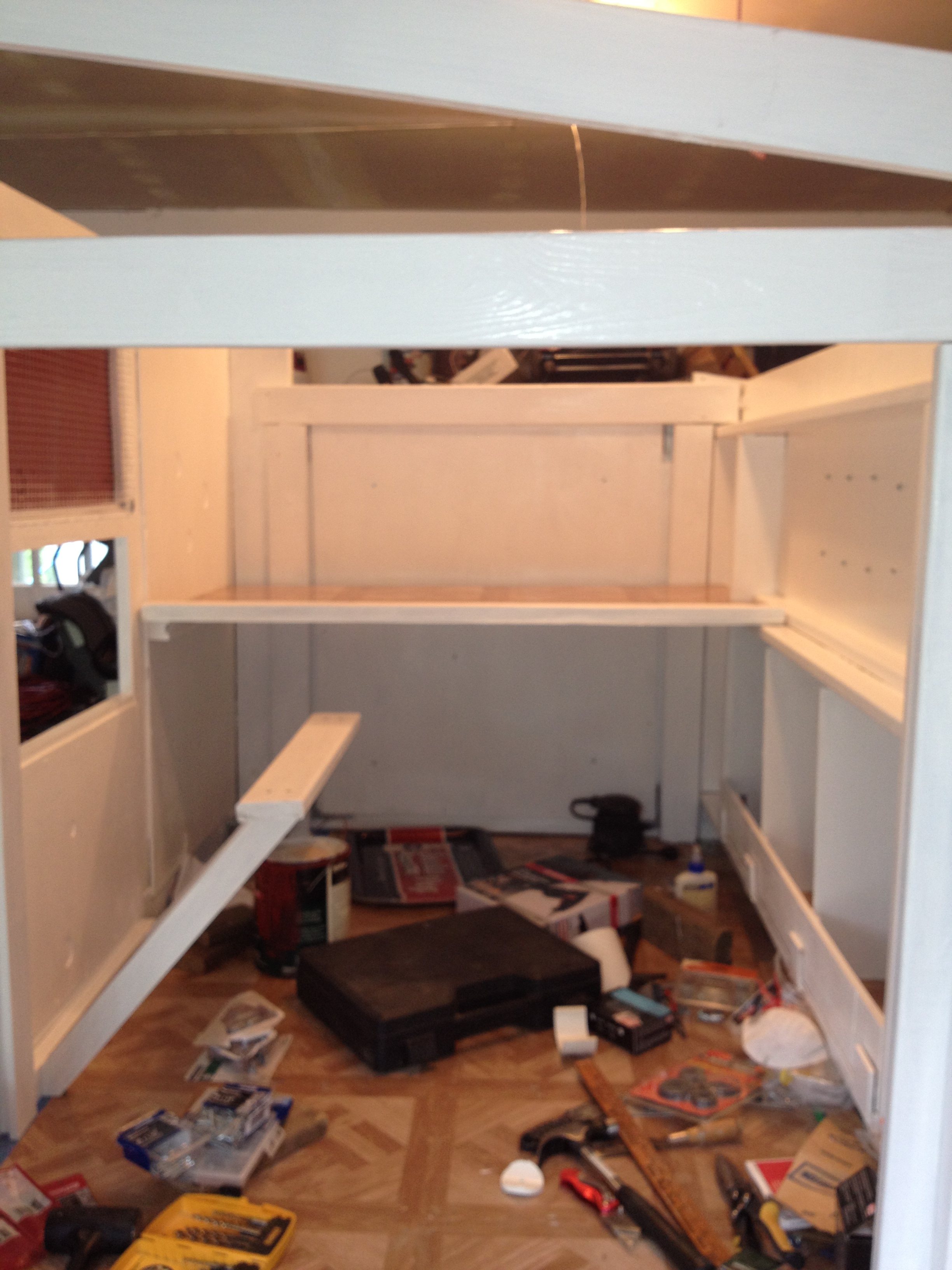Inside of coop - nesting boxes are to the right, droppings board across middle of coop (roost to be put in just over it), window to the left with a 2' perch in front in case the girls want to watch what's happening out in the yard.