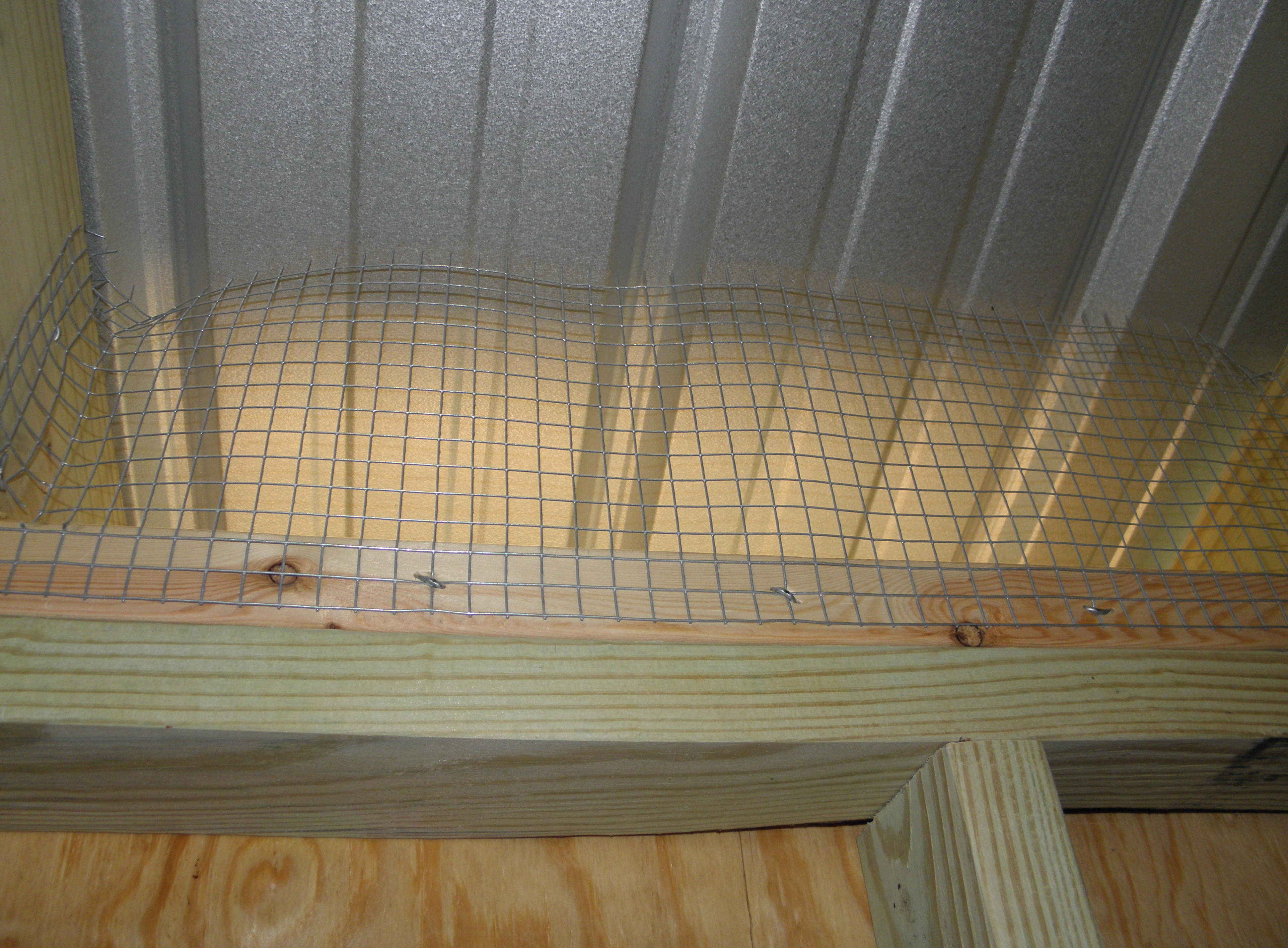 Inside the chicken coop, around the top.