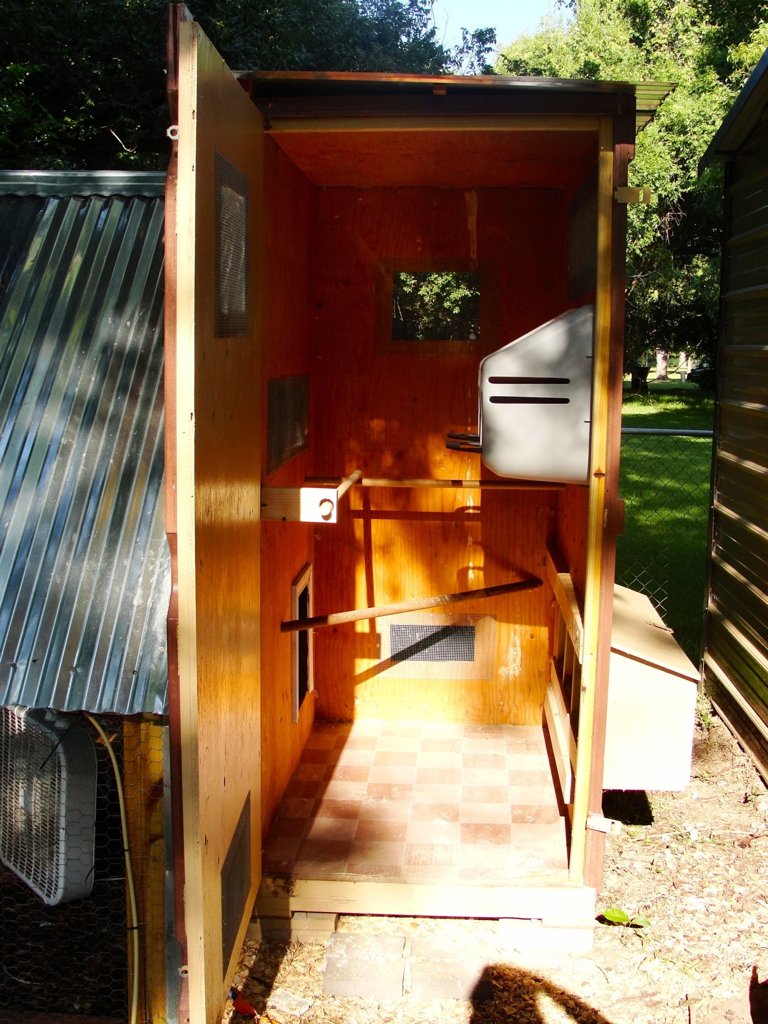 Inside the coop, 3 roosts and 5 nesting boxes. in the process of cleaning in these pictures, cedar chip shavings are always on the floor for our cornish rock rooster who cannot jump to roost.