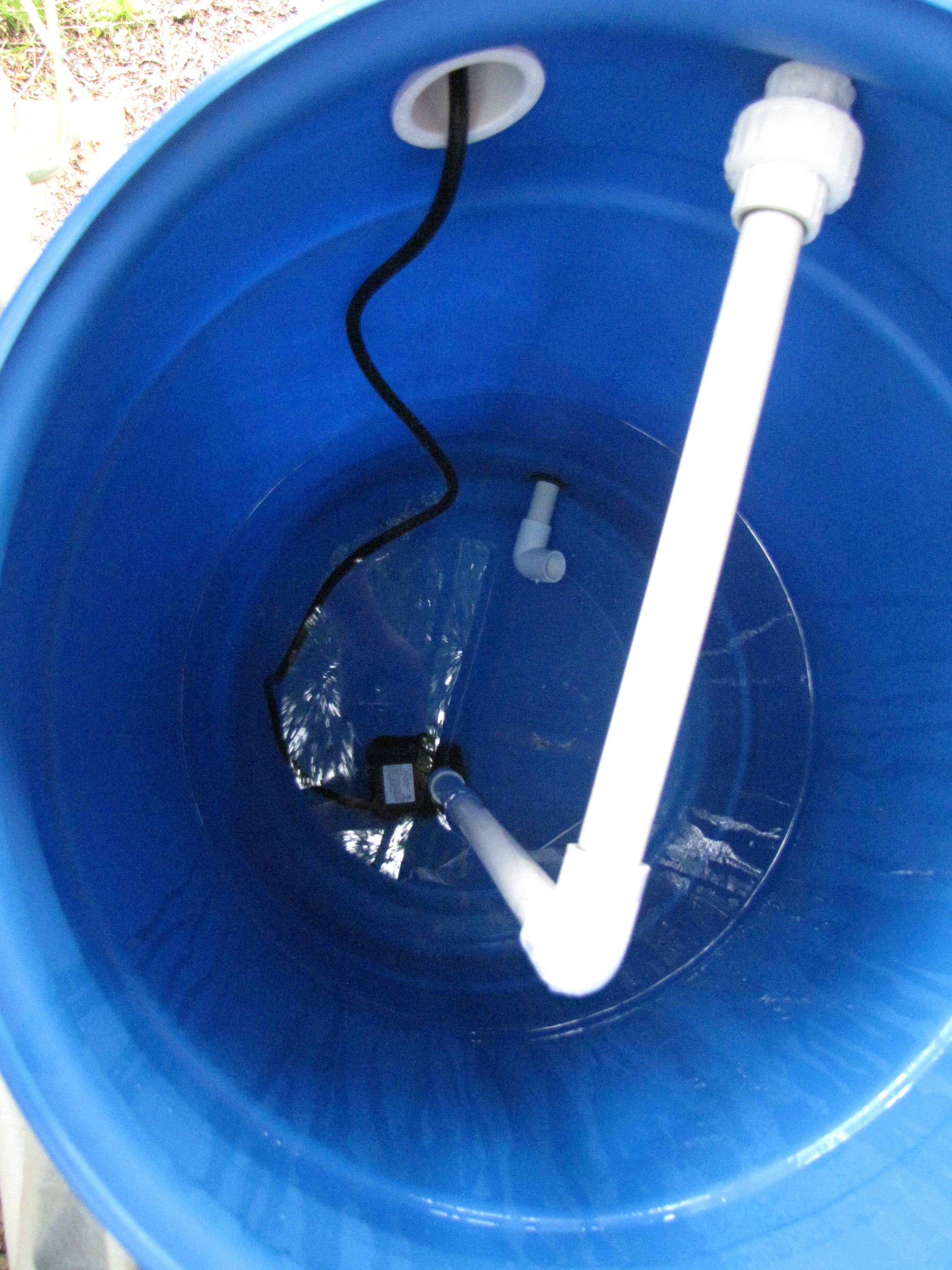 Inside the tank. Pump at the bottom, outlet thru the top. Inlet thru uniseal at bottom.