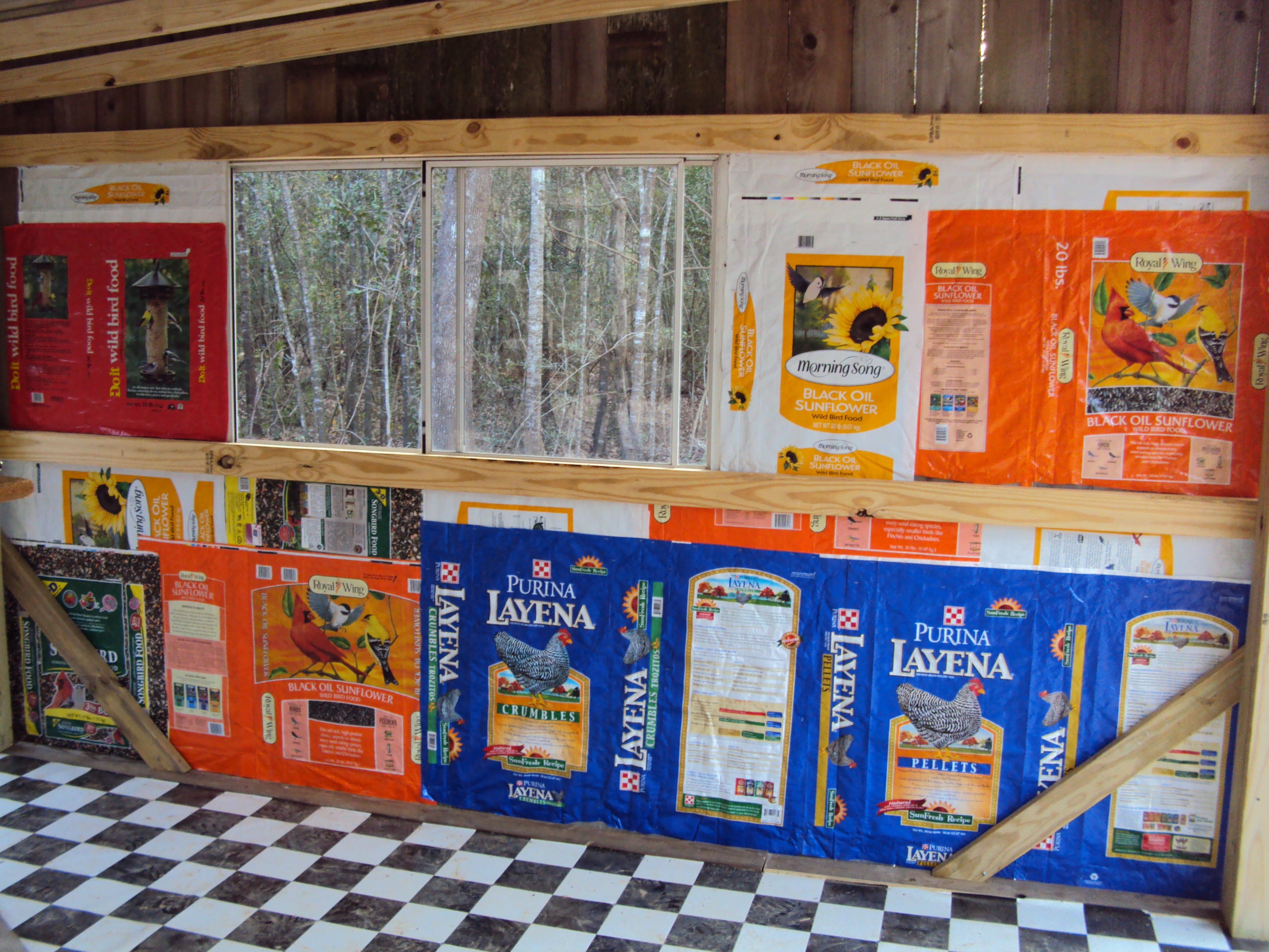Inside wall of feed room side.  Checkerboard linoleum and feed bags wallpaper.
