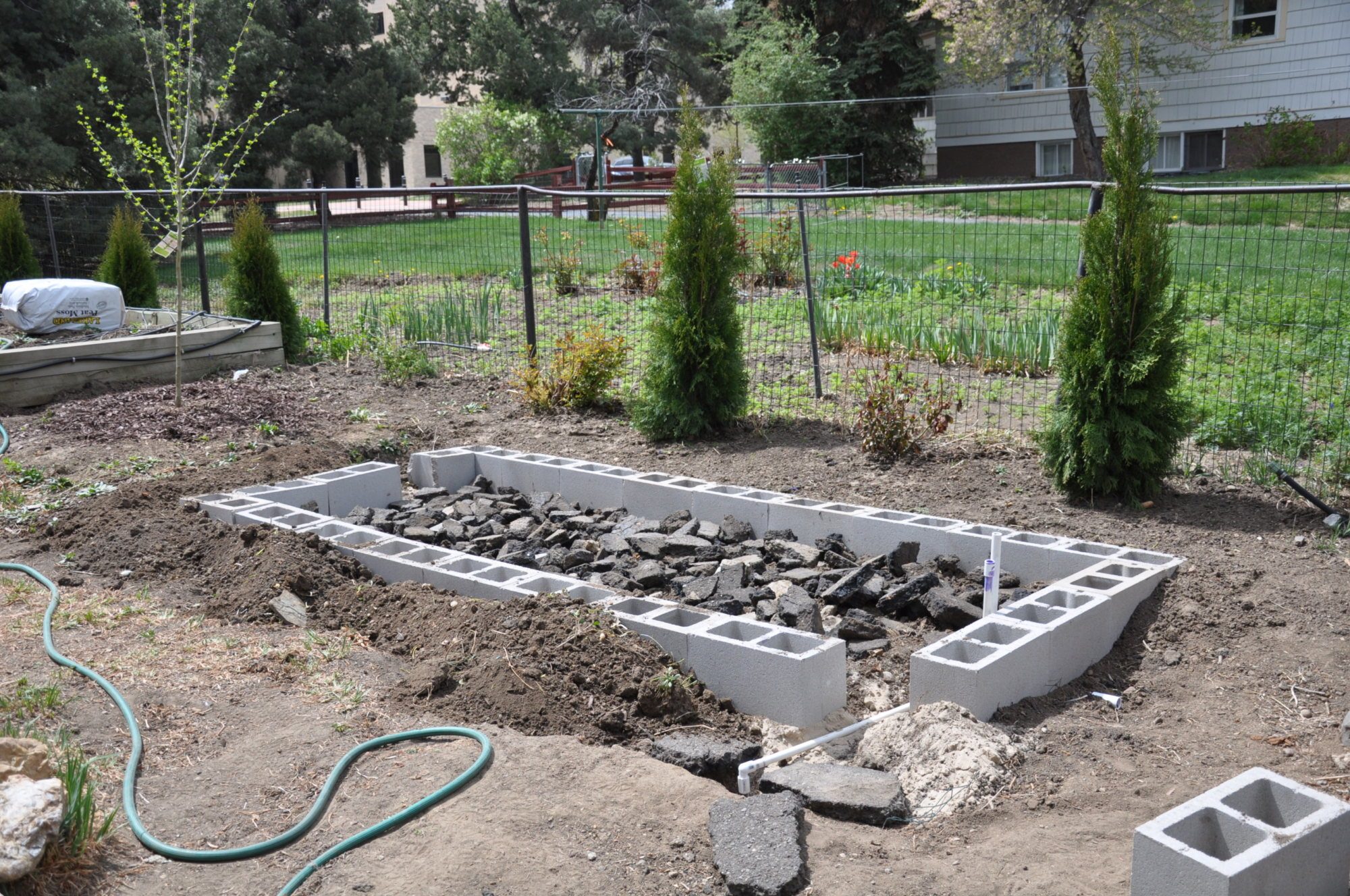 Installed CMU for the foundation footer.  Asphalt pieces are use for the run base.