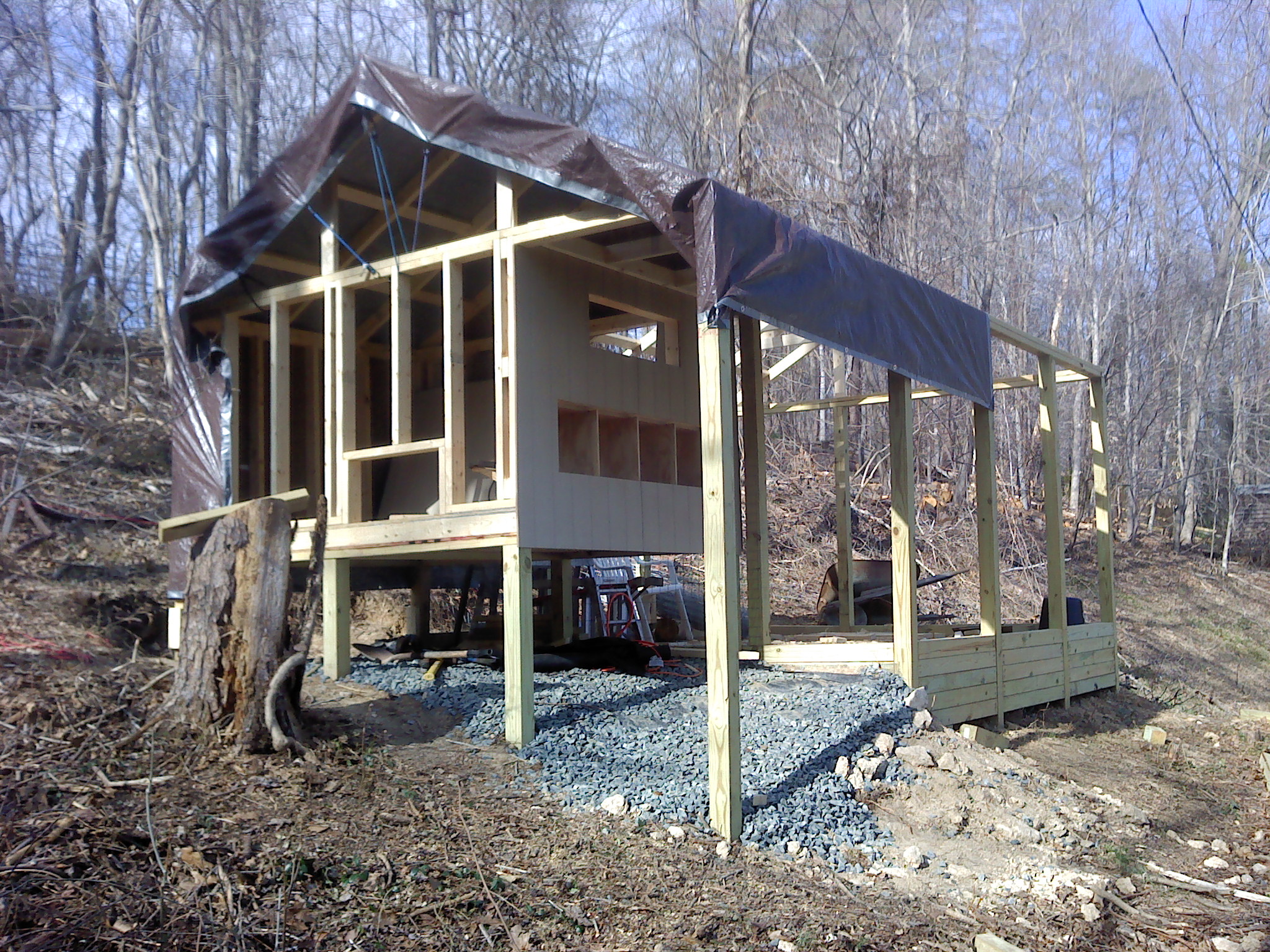 installed redwood siding. The tarp is to keep things dry, and keep me from getting too much sun. Ordering metal roofing tomorrow. Chicks were ordered last night ( 3 Barred Rock, 3 Australorp, and 3 Golden Comets), they should arrive around the 2nd week in April. It is now 3/9/2012