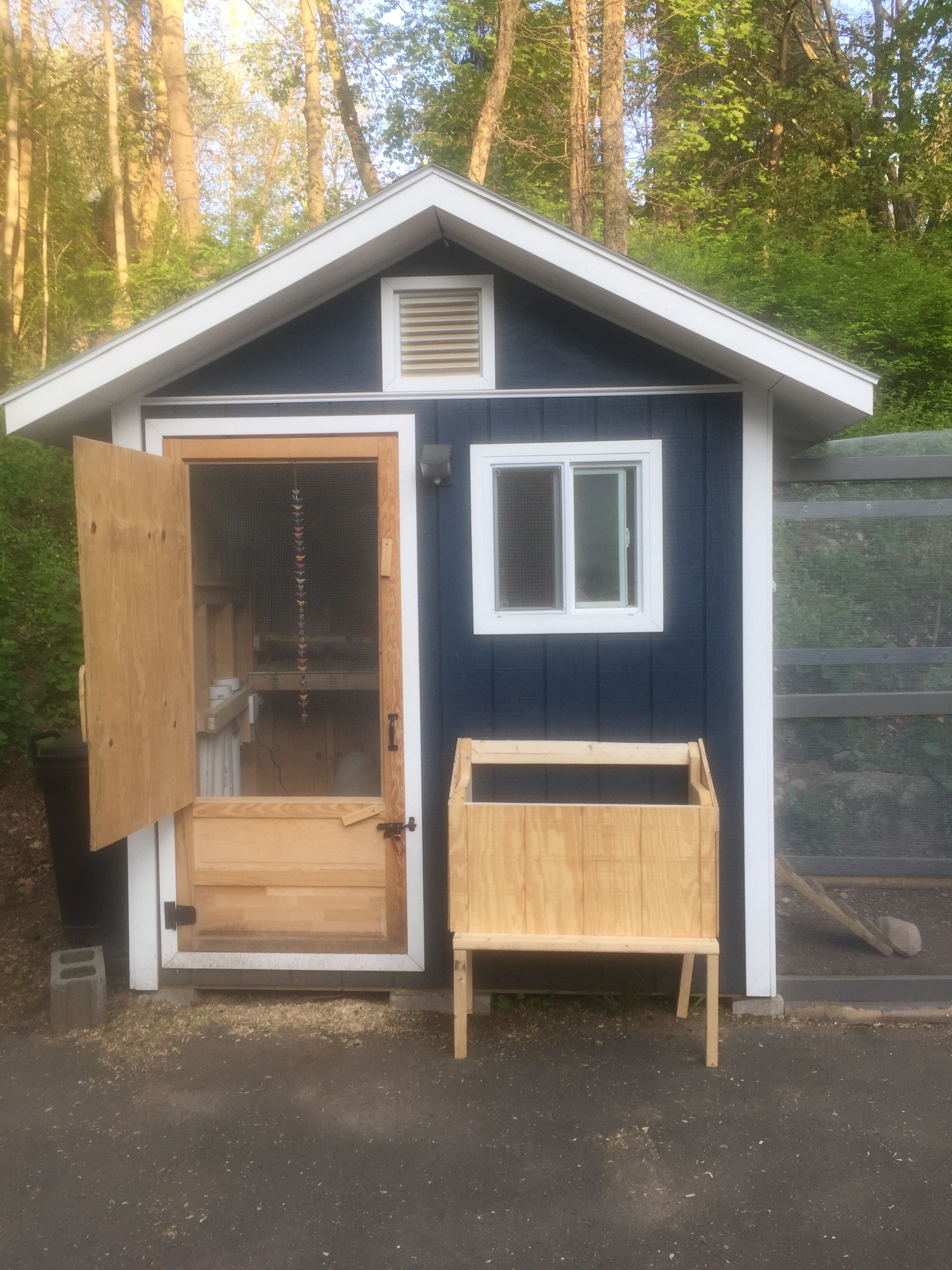 Installing a new nest box outside of the coop.  I wish I'd cut the holes in the siding before I attached the box!!  I had to cut them from the inside with a jigsaw and it was a PITA
