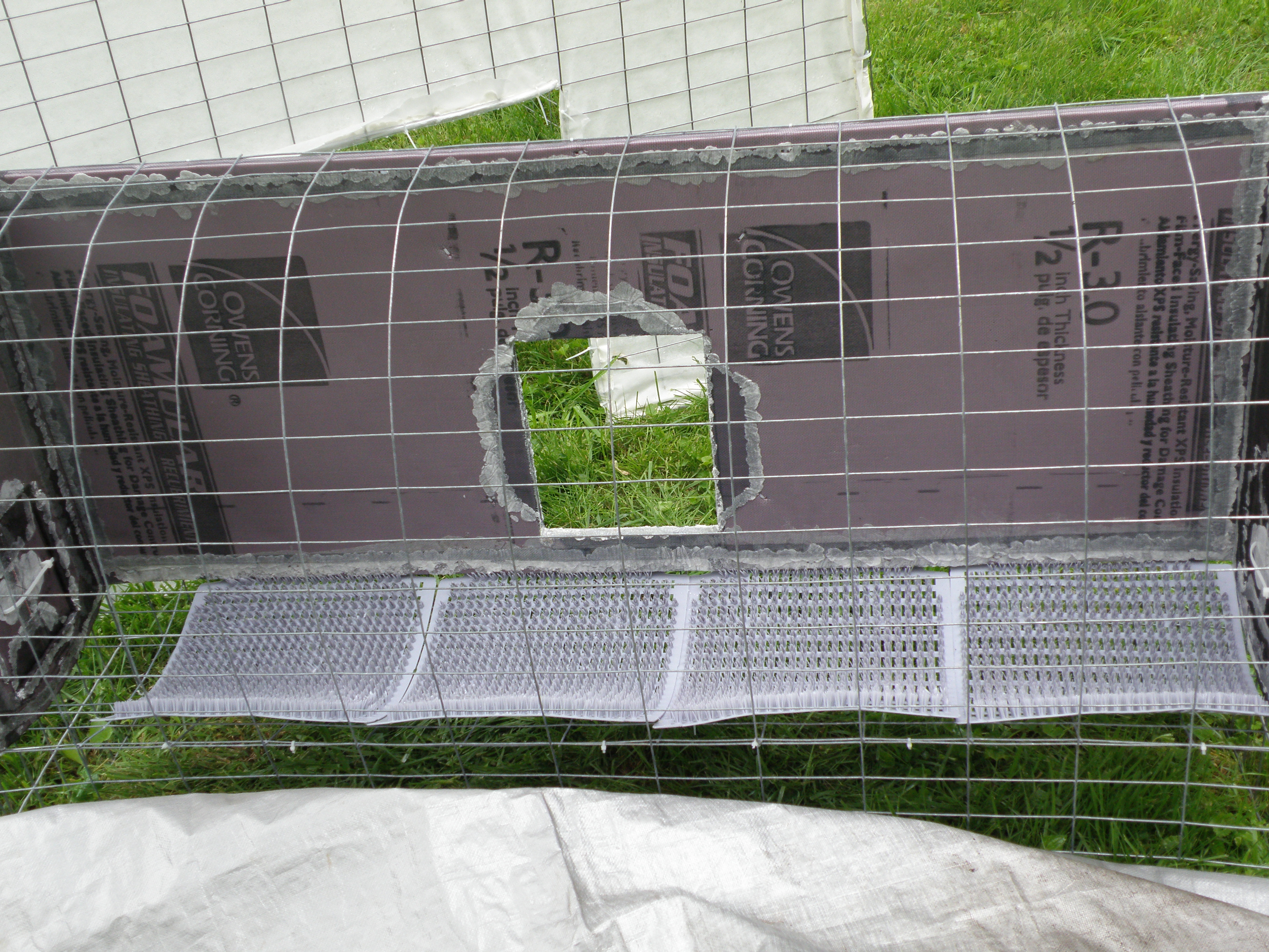 Interior of nest box with peck resistant foam board and nest pads