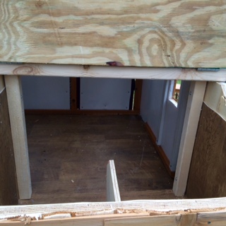 Interior of the coop looking in through the nesting box lid.