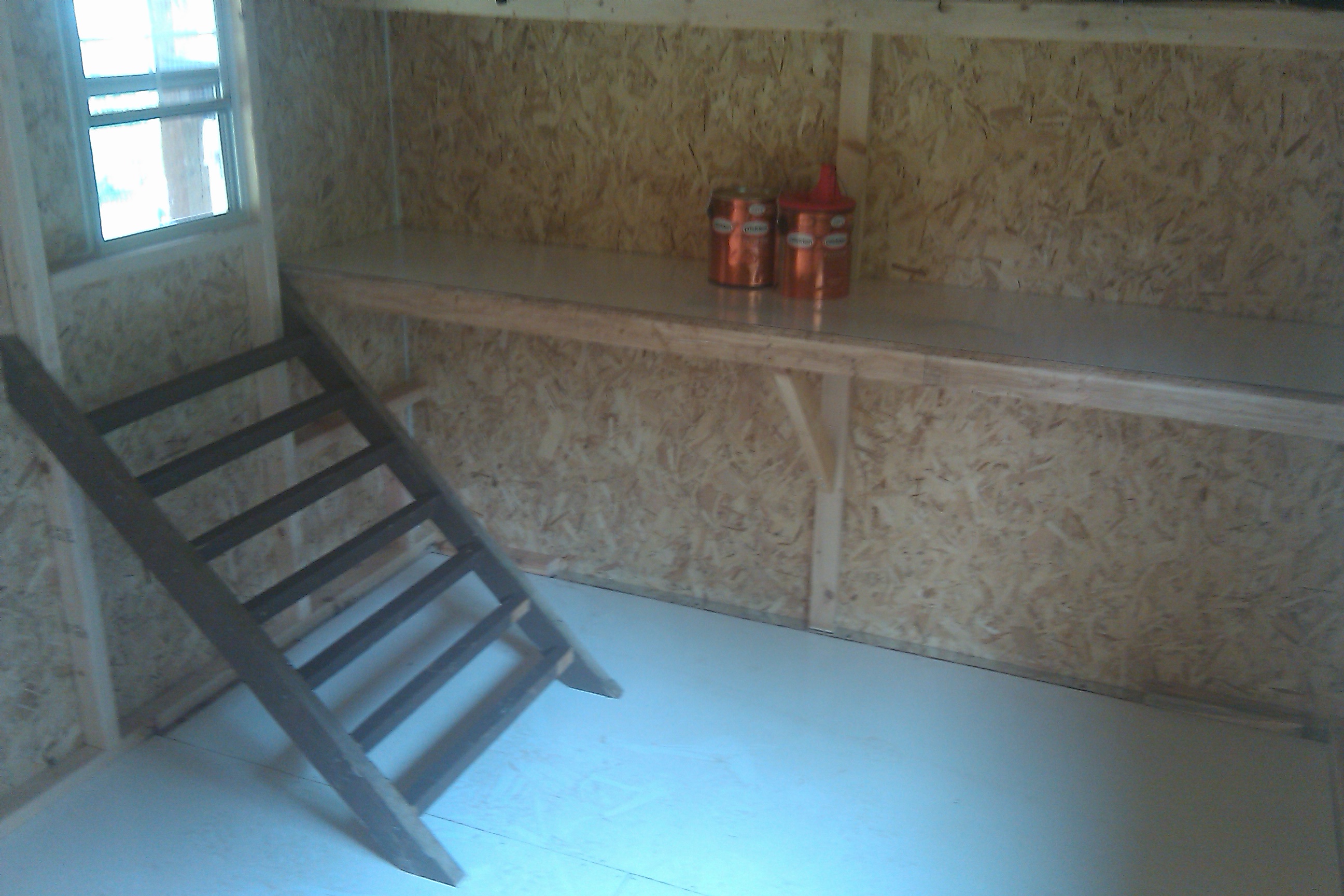 Interior roost.  I put thin Melanine on the floor, hoping it would make the cleanup easier, it didnt...  The BO's were using the roost here until I integrated the 2nd flock of birds.  Now they all roost on the upper shelving - whoever gets the highest roost wins I guess...