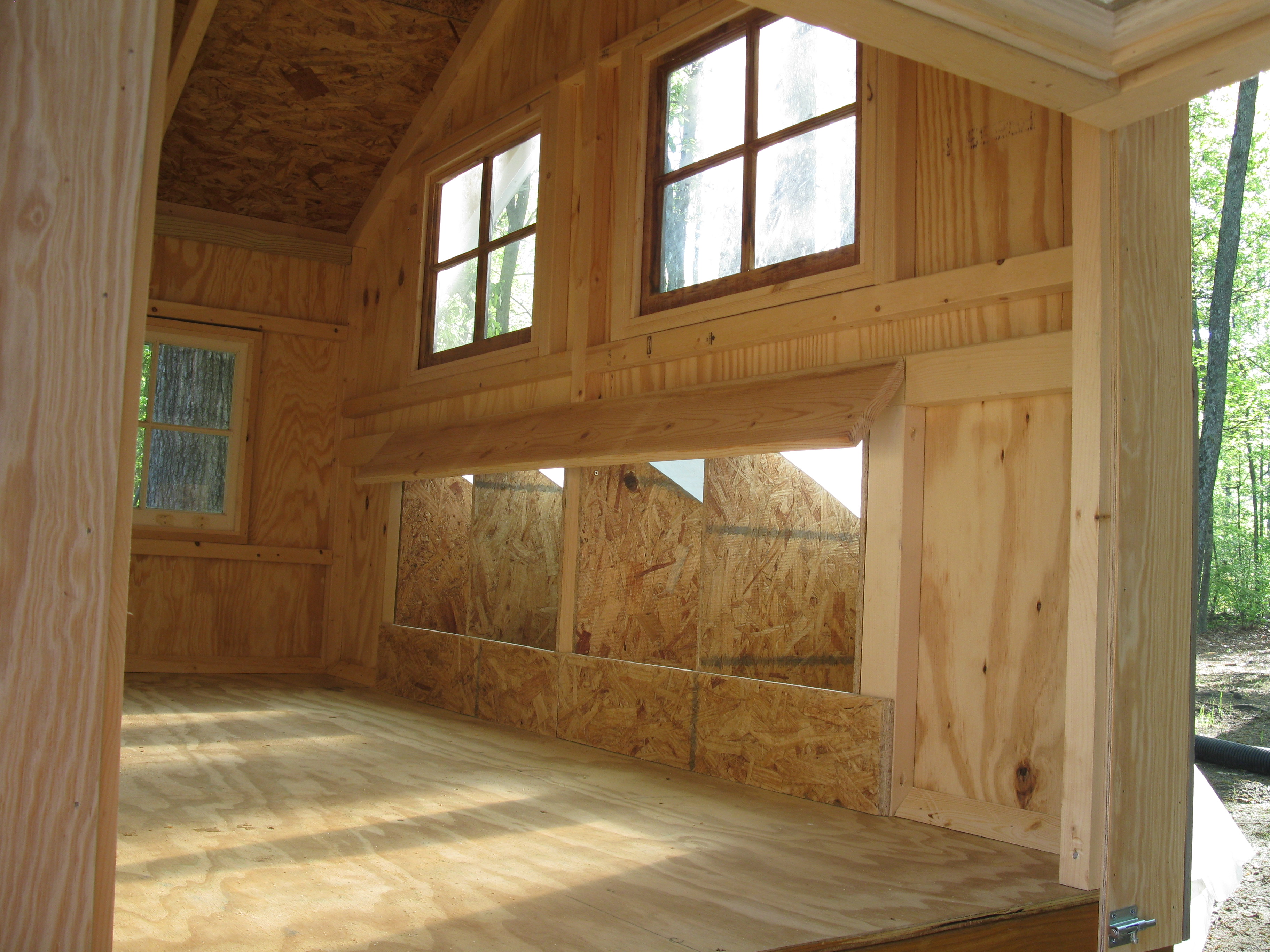 Interior shot showing the nesting boxes and hatch door on one end, good for cleanout.  There is also a hinged window sash in the hatch door.