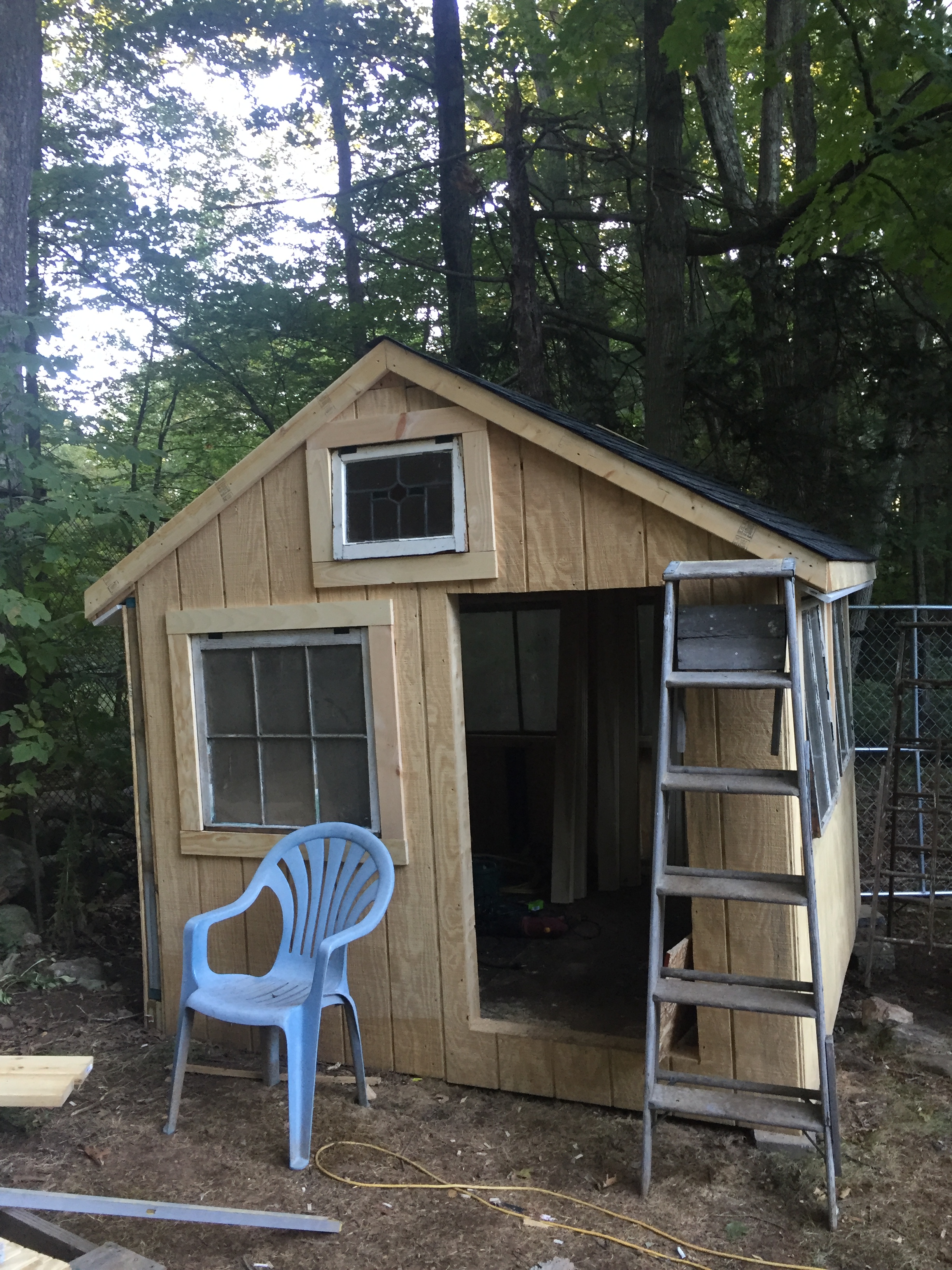 It's coming along.  This is the people door and the west facing side of the coop.  I built this whole thing around the little window in the peak.