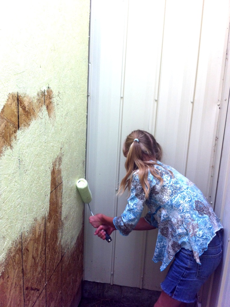 Jessie helping paint the outside wall