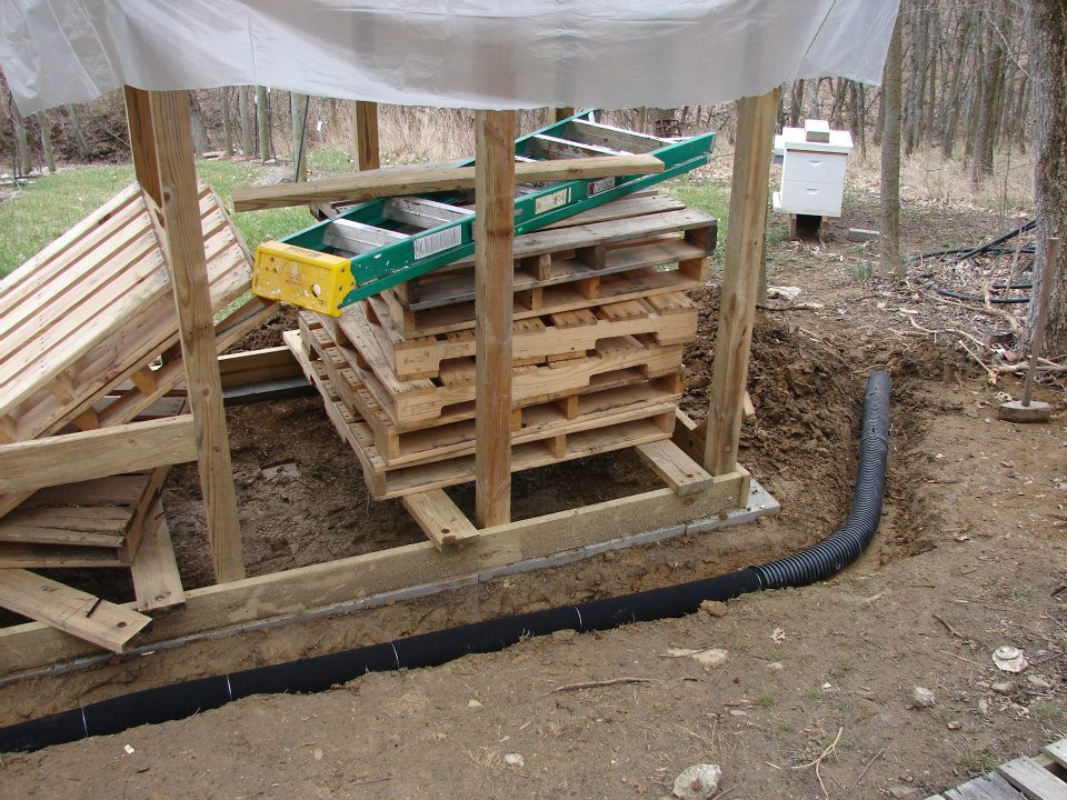 Laying perforated drain pipe.*