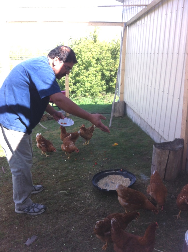 Lito feeding chickens for the first time in his life- he loves this