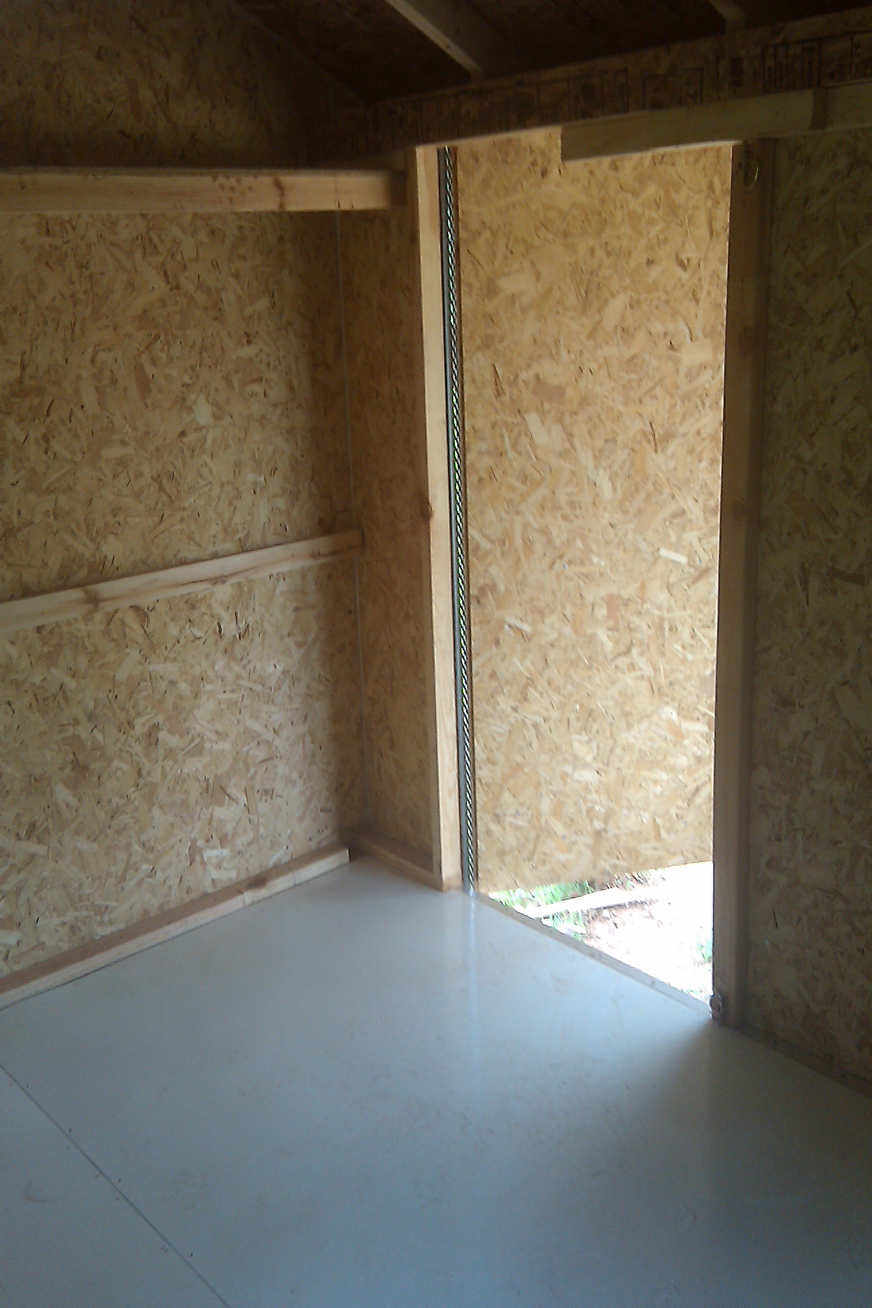 Man Doors - arguably the biggest mistake was situating the covered porch under the eves of the coop, which prevents the doors from opening fully.  Putting the porch roof above the coop roof would have required a gutter under the coop roof, which would have prevented the door from opening at all.  This kit shed was not designed for a gutter...  next time I'll do better.
