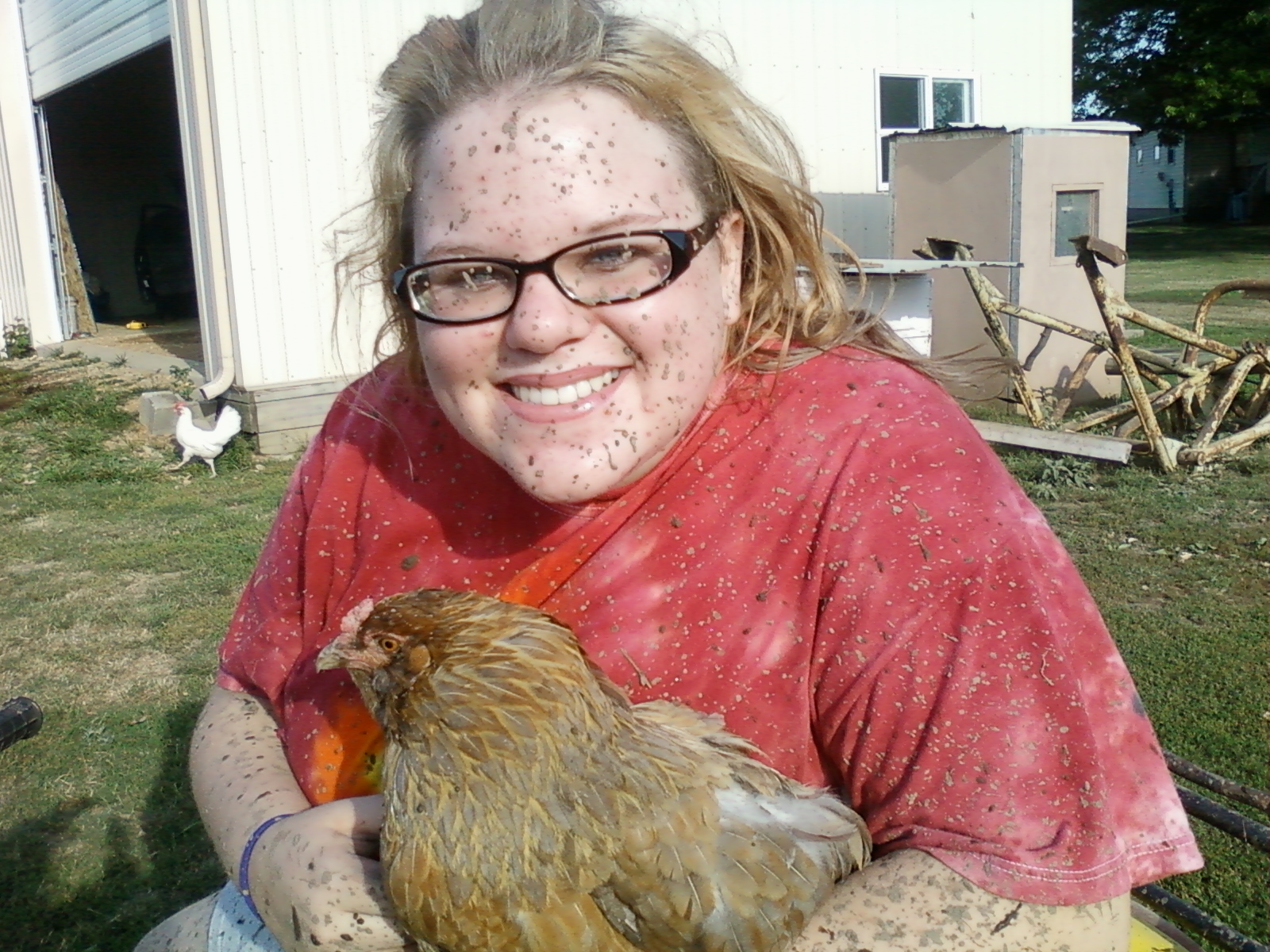me after muddin in my four wheeler with my adorable ameraucana hen, Sweetheart