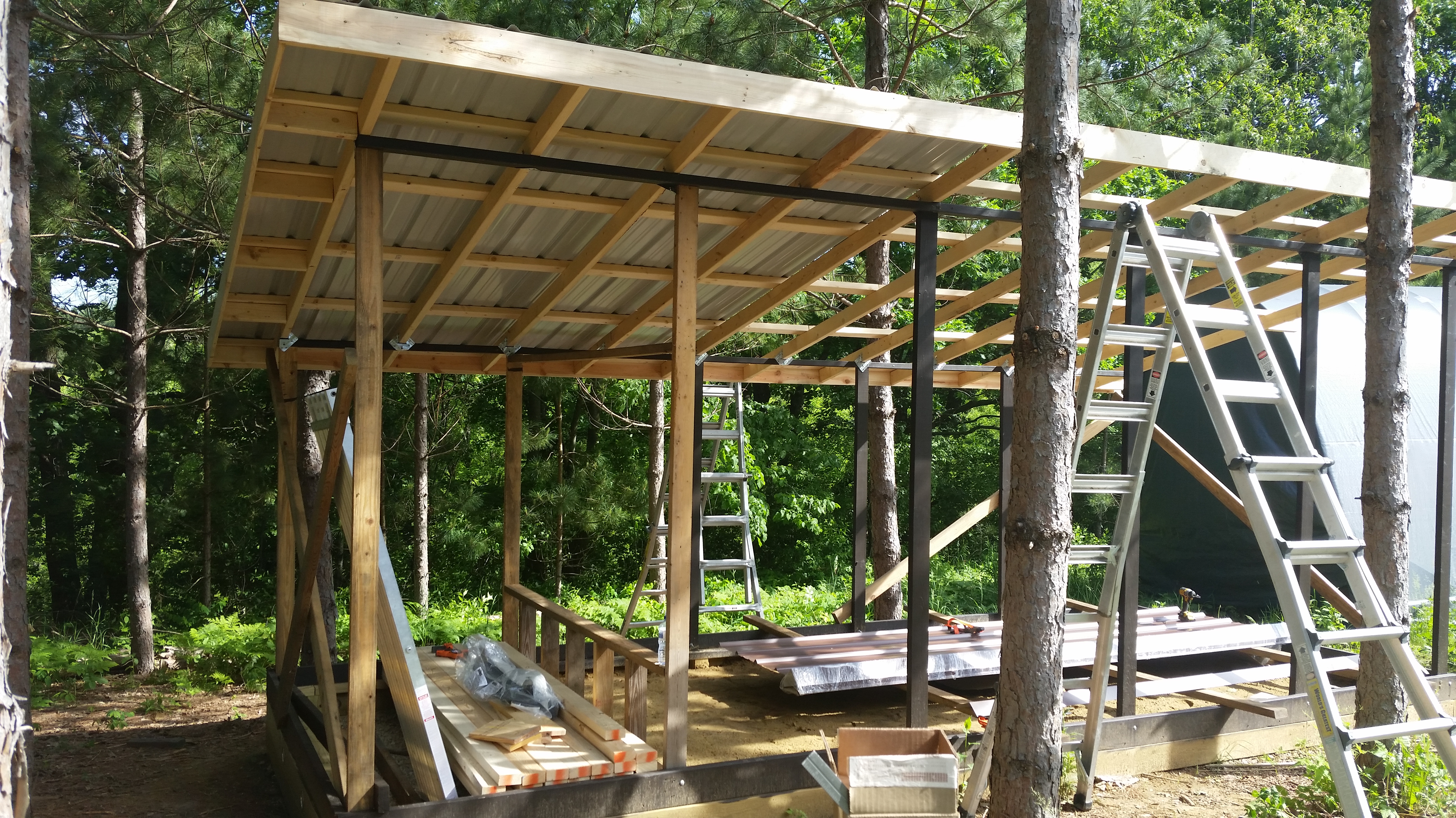 Metal roofing going on.  I ordered these sheets custom pre-cut, so they span full length with no horizontal seams.