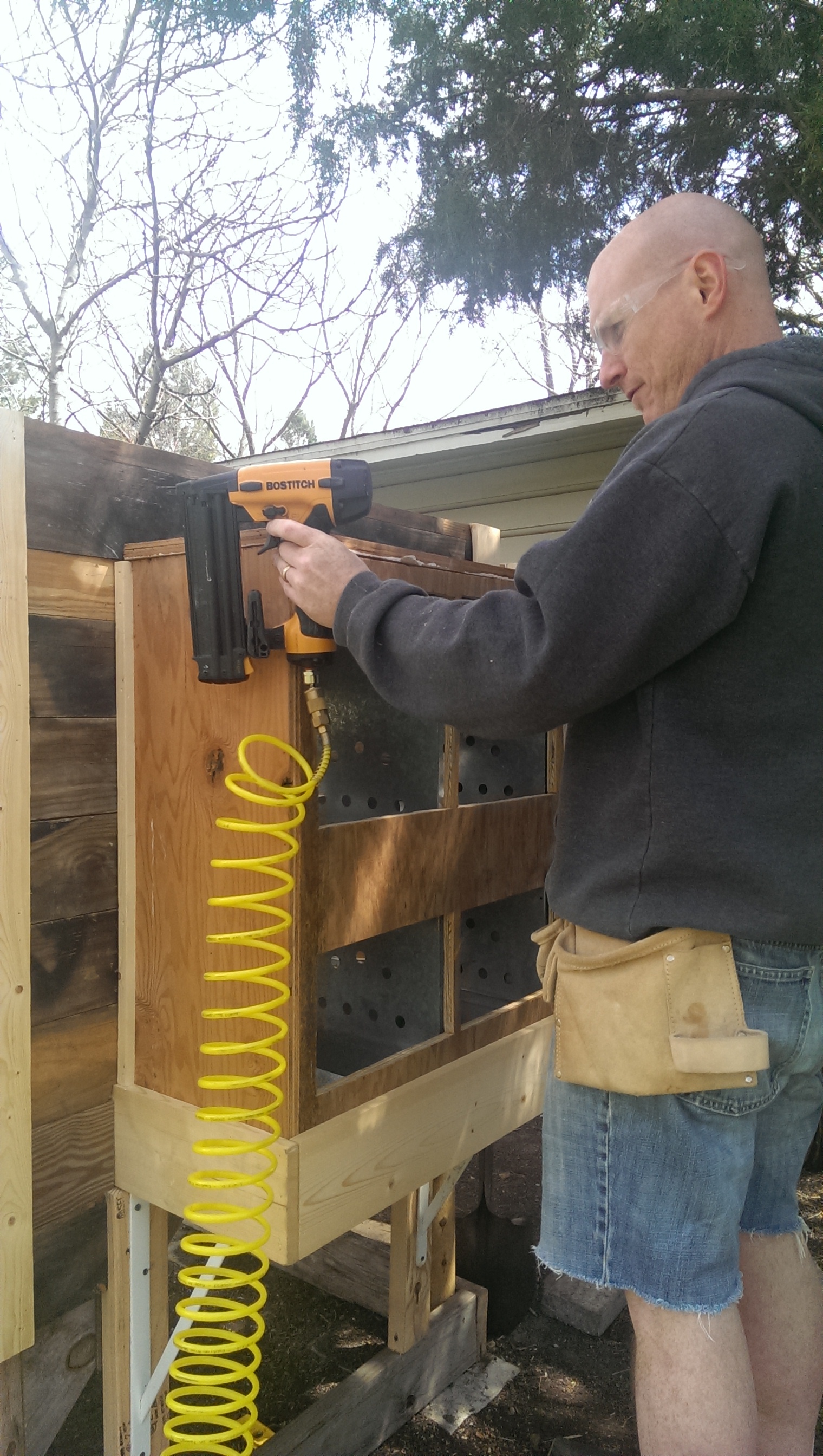 Mounting the nesting boxes onto the back, we were going to put them inside but it looked too crowded. Josh supported the boxes with some metal shelving brackets that we salvaged from a closet that was removed  in a former house project :D reuse!