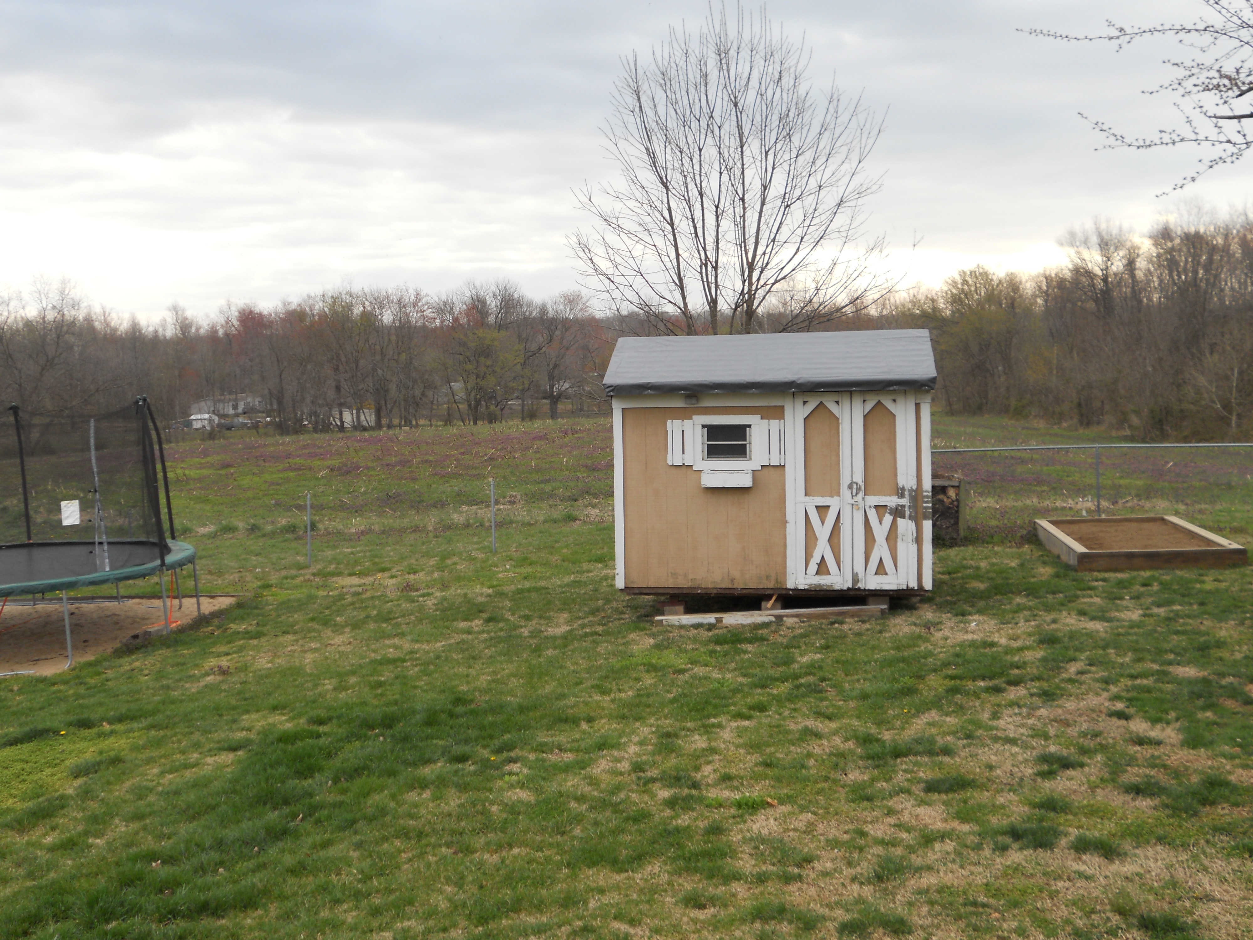 Moved a free old yard barn from local farm to our backyard using a tractor. We set the yard bard on a hay bail lifter and used ratchet straps.