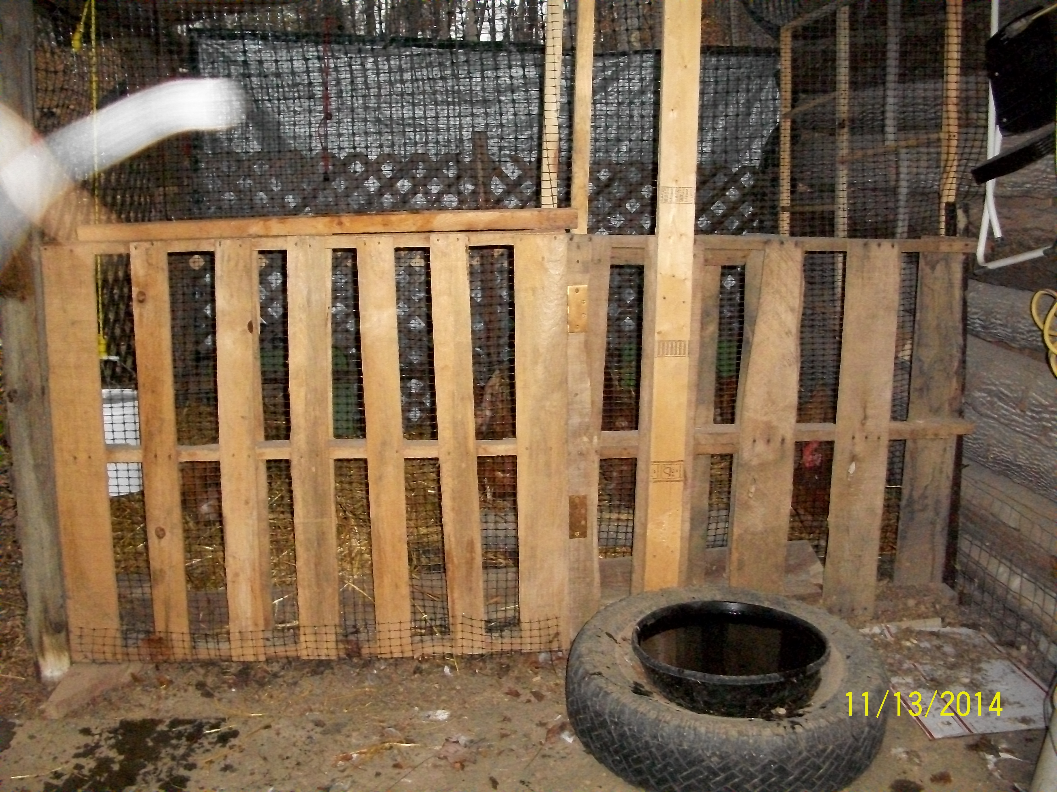 Multipurpose spare pen built from pallets onto the end of a shed porch.