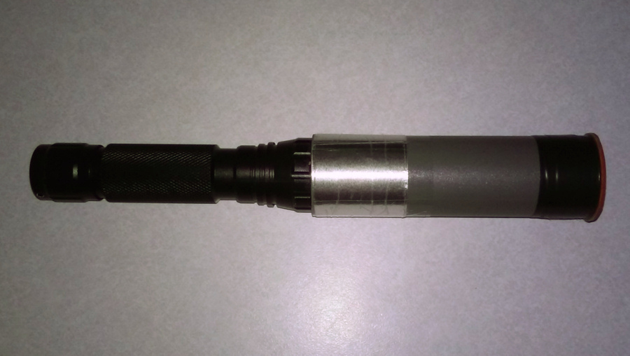 My candler:
5W (approx. 450 lumens) LED torch. 
Uses a 3.7v 4000mAh 18650 battery.
(Extended with a tube to reduce heat emitted by the source). 

It lights up the egg very well, with near-zero light bleed.