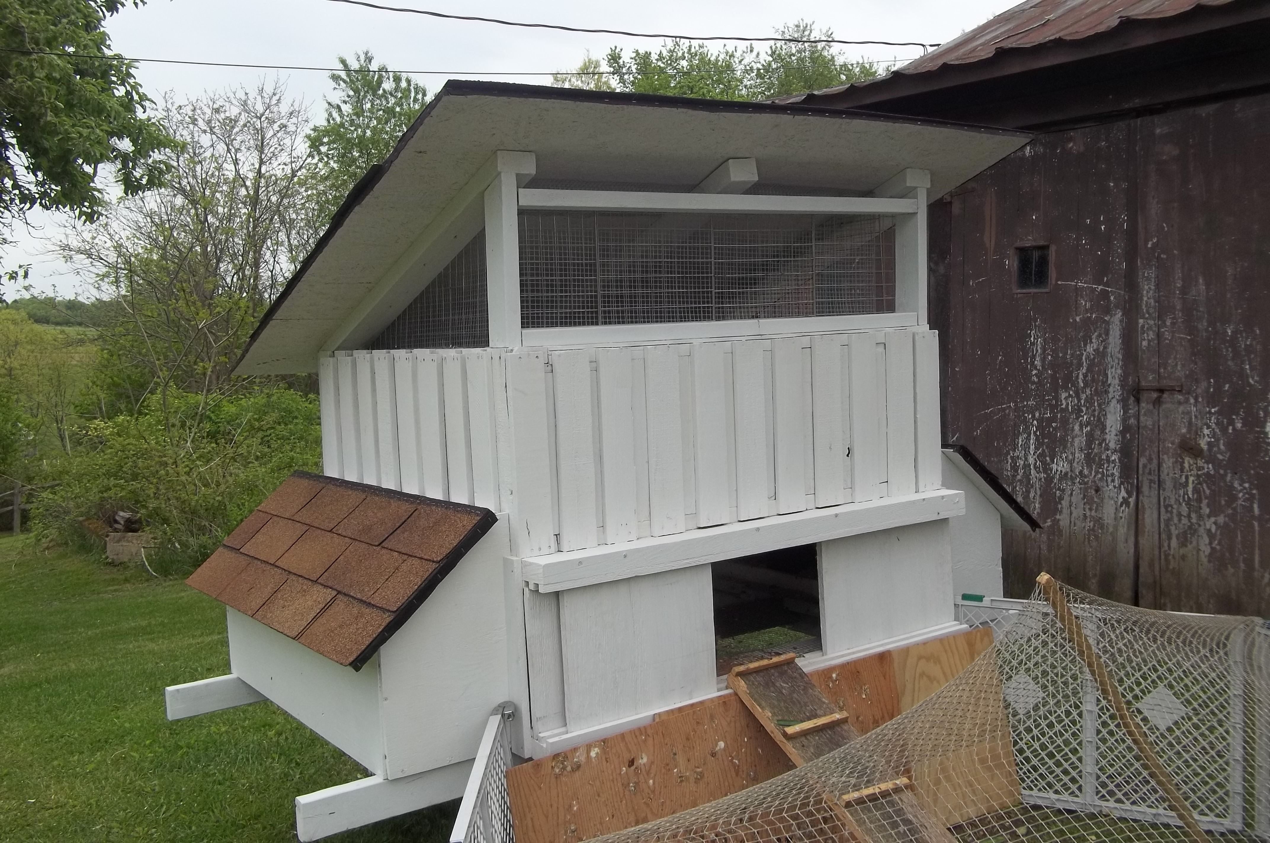 My Coop.  Built out of 3 Pallets & scrap lumber / singles.  Only cost was the hardware clothe and the hinges. It hasn't been placed in it's permanent home yet, but the girls are calling it home where it sits.