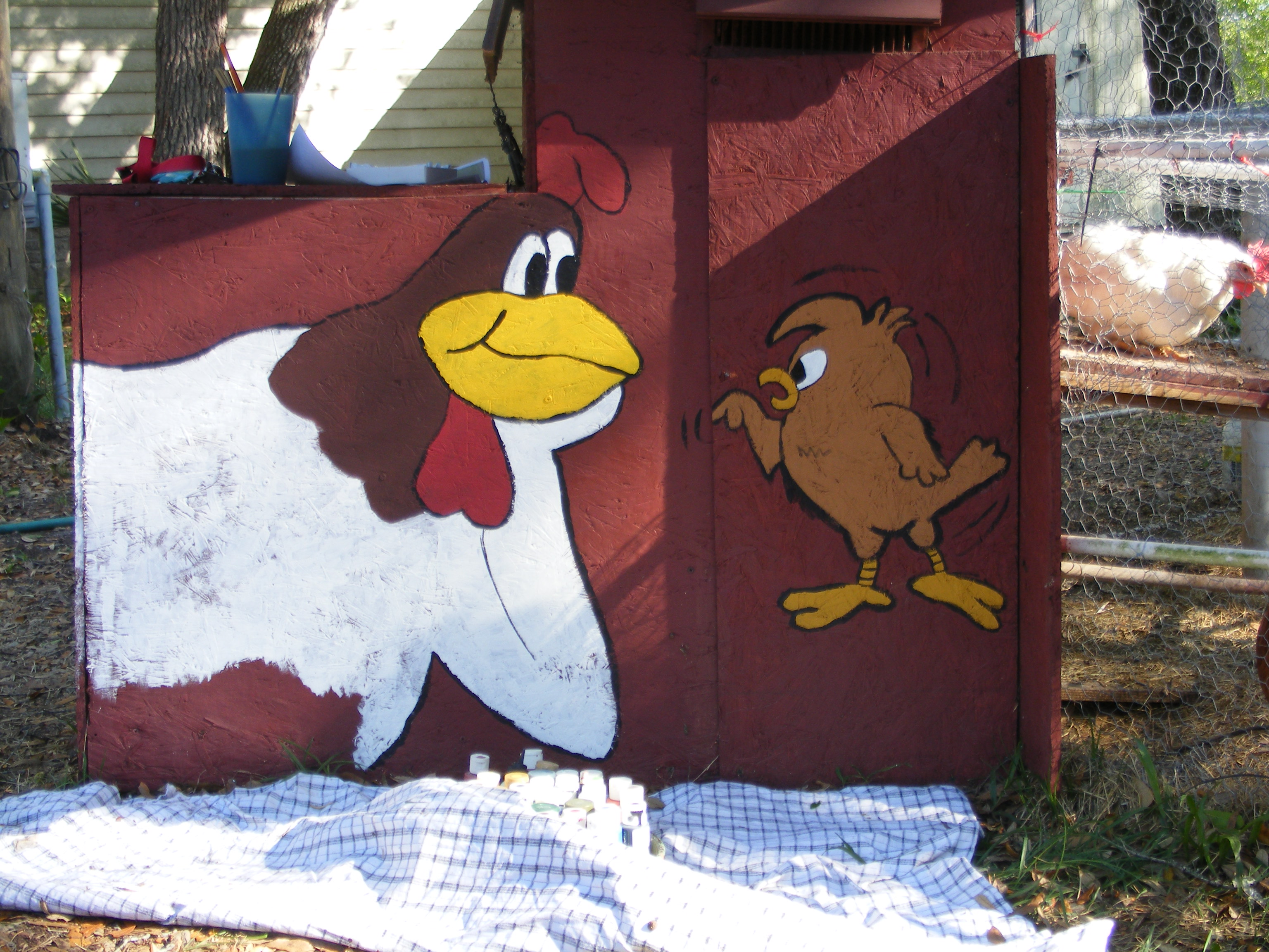 My First Coop, Made from an old above ground pool frame some left over wood and tin from roofing a pole barn the paint was a returned color at home depot the whole gallon for $5 our neice hand painted the Foghorn Leghorn and chicken hawk on the coop.