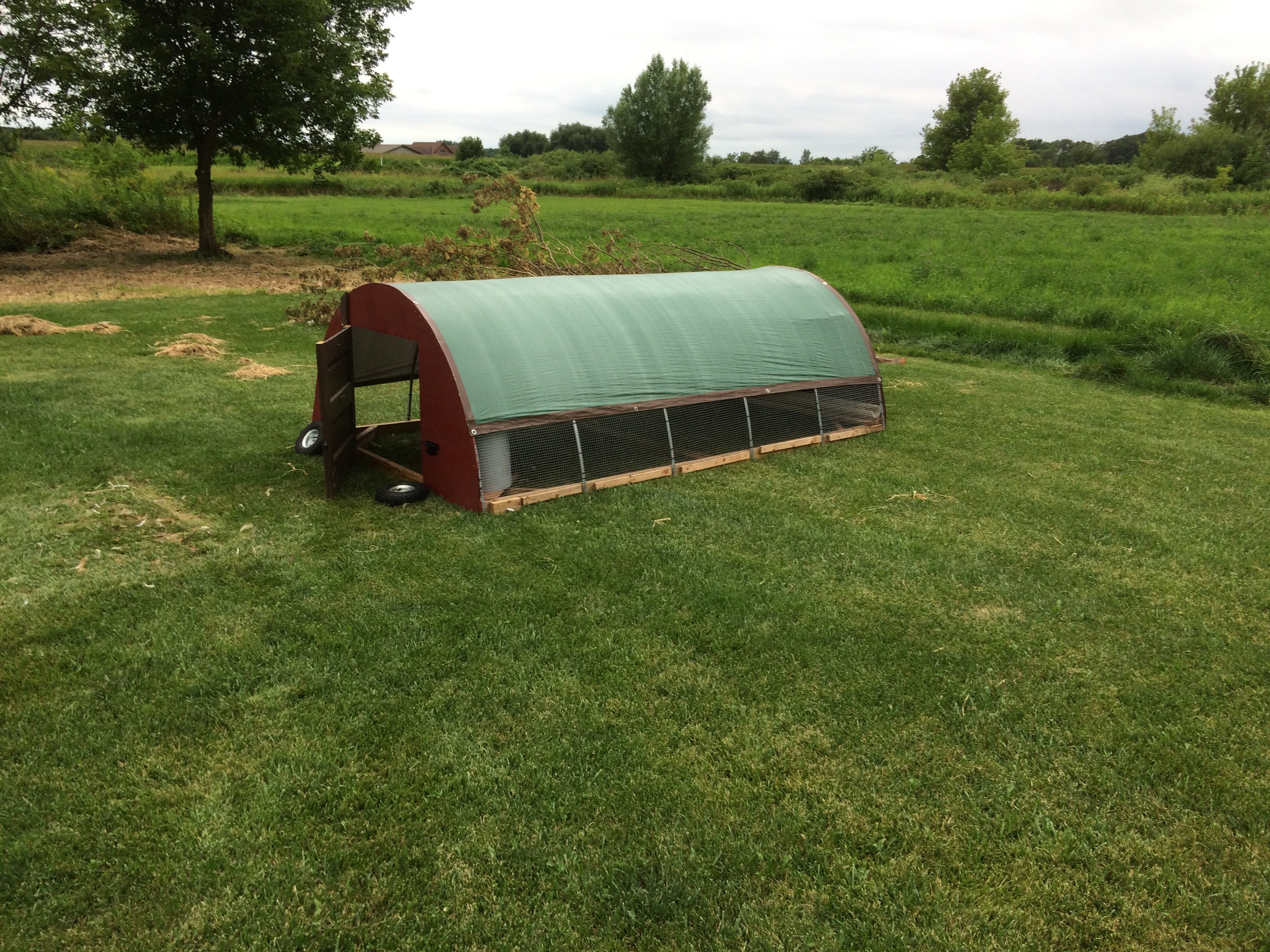 My home built hoop house that houses about 20-25 Broilers.  6' x 10'

Base is made of pressure treated 2x4, the ends are 1/2" plywood painted with oil barn paint.  The hoops are 1/2" EMT conduit and the covering is 1/2"  hardware cloth and an 8x10 light duty tarp