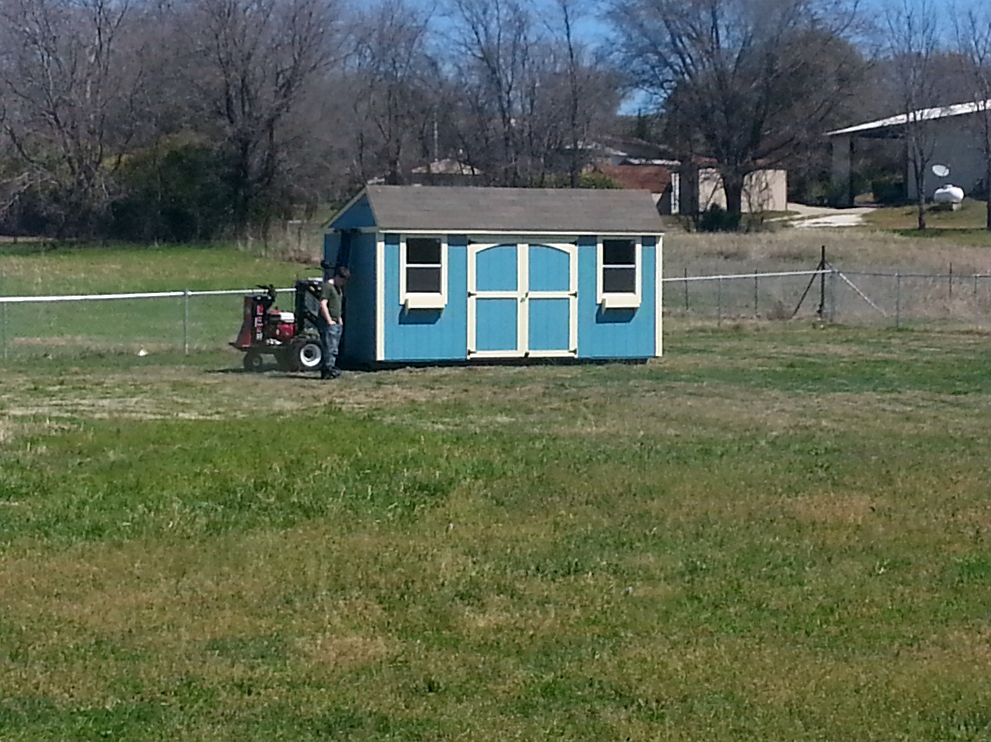 My new chicken coop and the amazing hubby who bought it for me. It's 8' x 16' and the run is going to go behind it and be 25' x 16'. I was just going to let them free range until I saw a hawk snatch up a full grown rabbit and fly off with it. They don't stand a chance