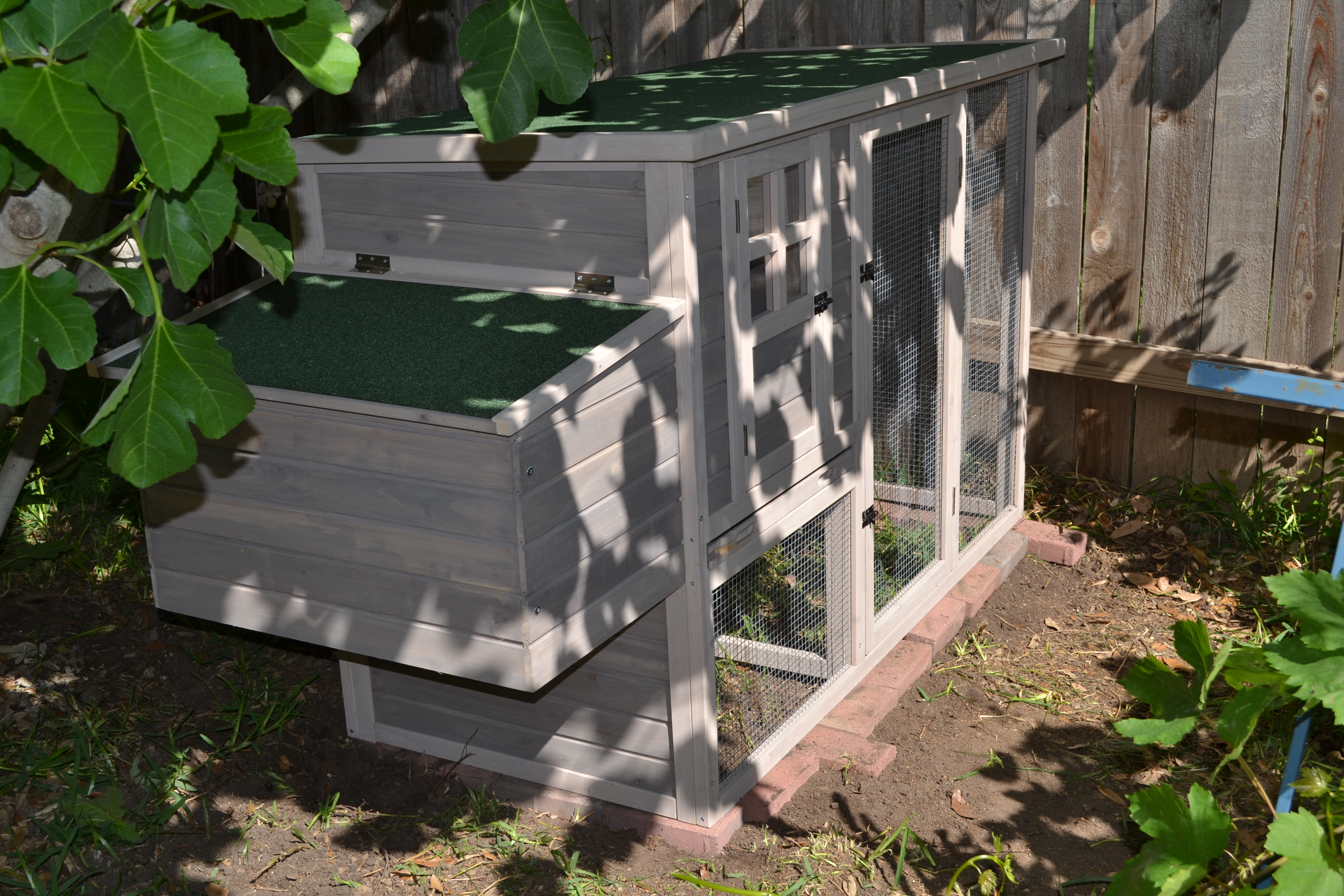 My sons inserted a perimeter of bricks underneath the hutch to prevent wood/soil direct contact.