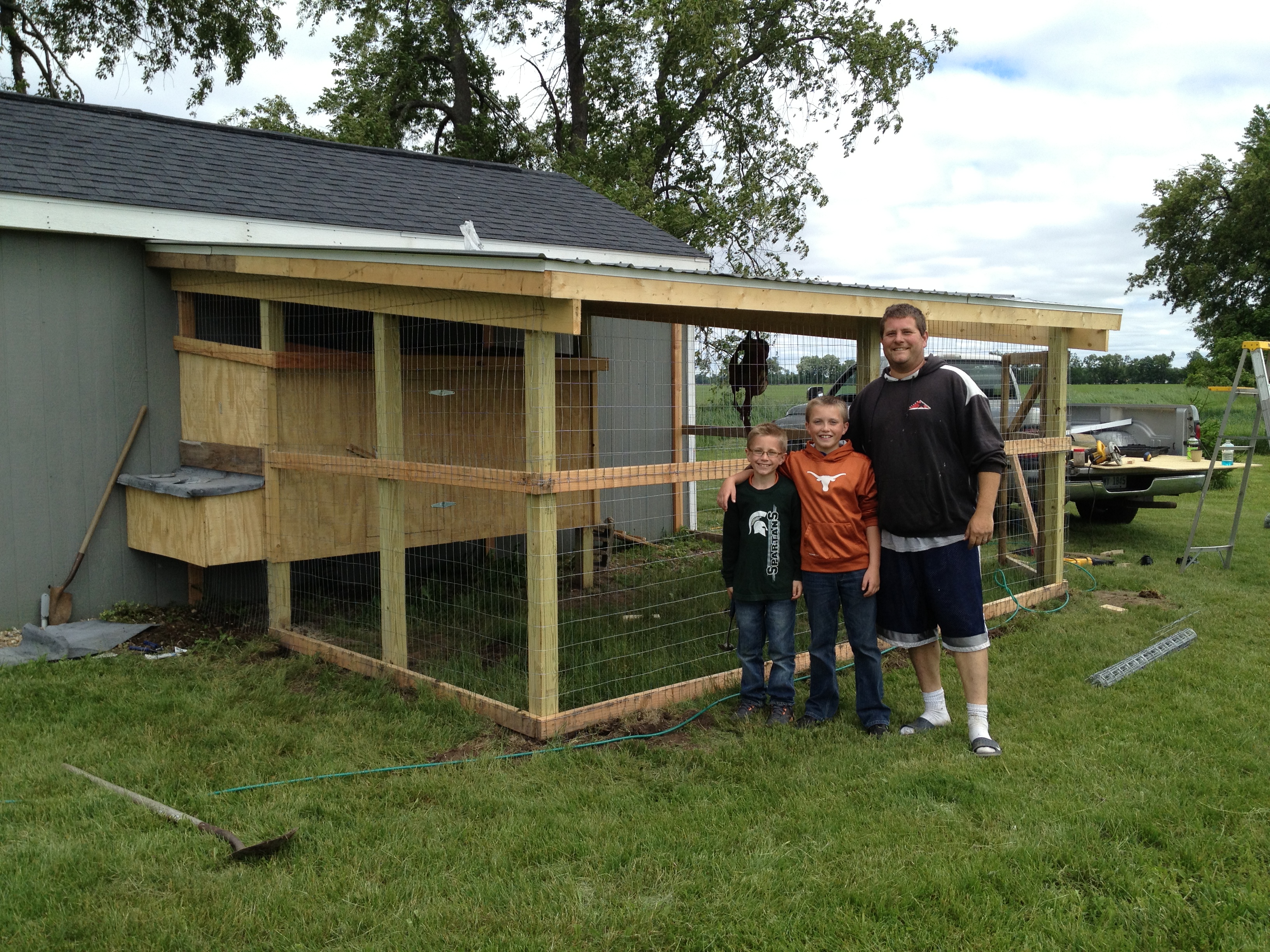 My two oldest boys helping their uncle build out coop! :)
