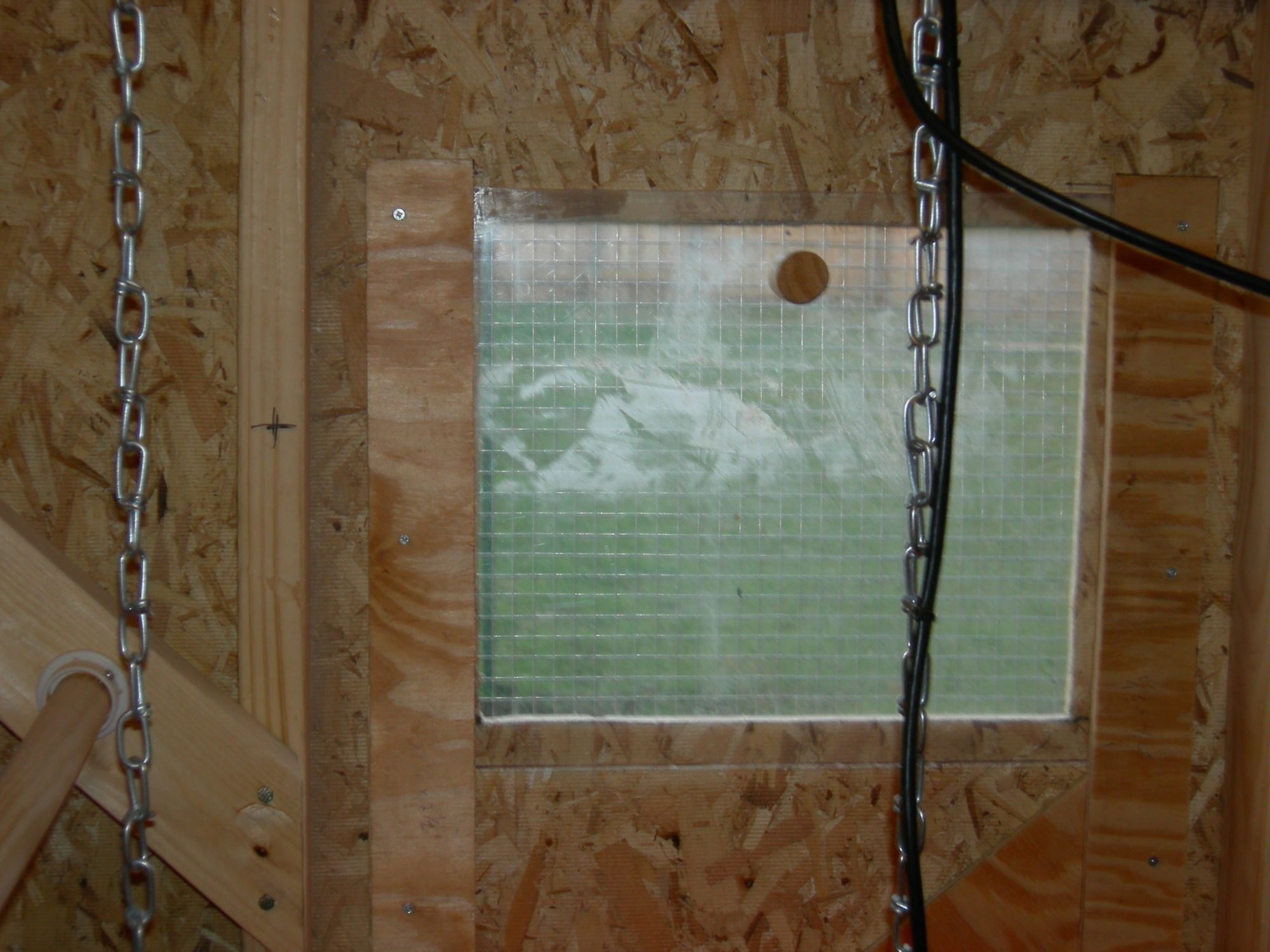 Not sure if you can tell from the photos but the windows my husband designed are fully functional. They can be opened all the way when it is warm outside or partially when it is slightly chilly. They can also be completely closed when the temps drop to keep out the north winds. Of course they aren't air tight like house windows but they block a lot of drafts. You can see the wooden know at the top center and just barely see the diagonal brace at the bottom right that holds the window in the closed position.