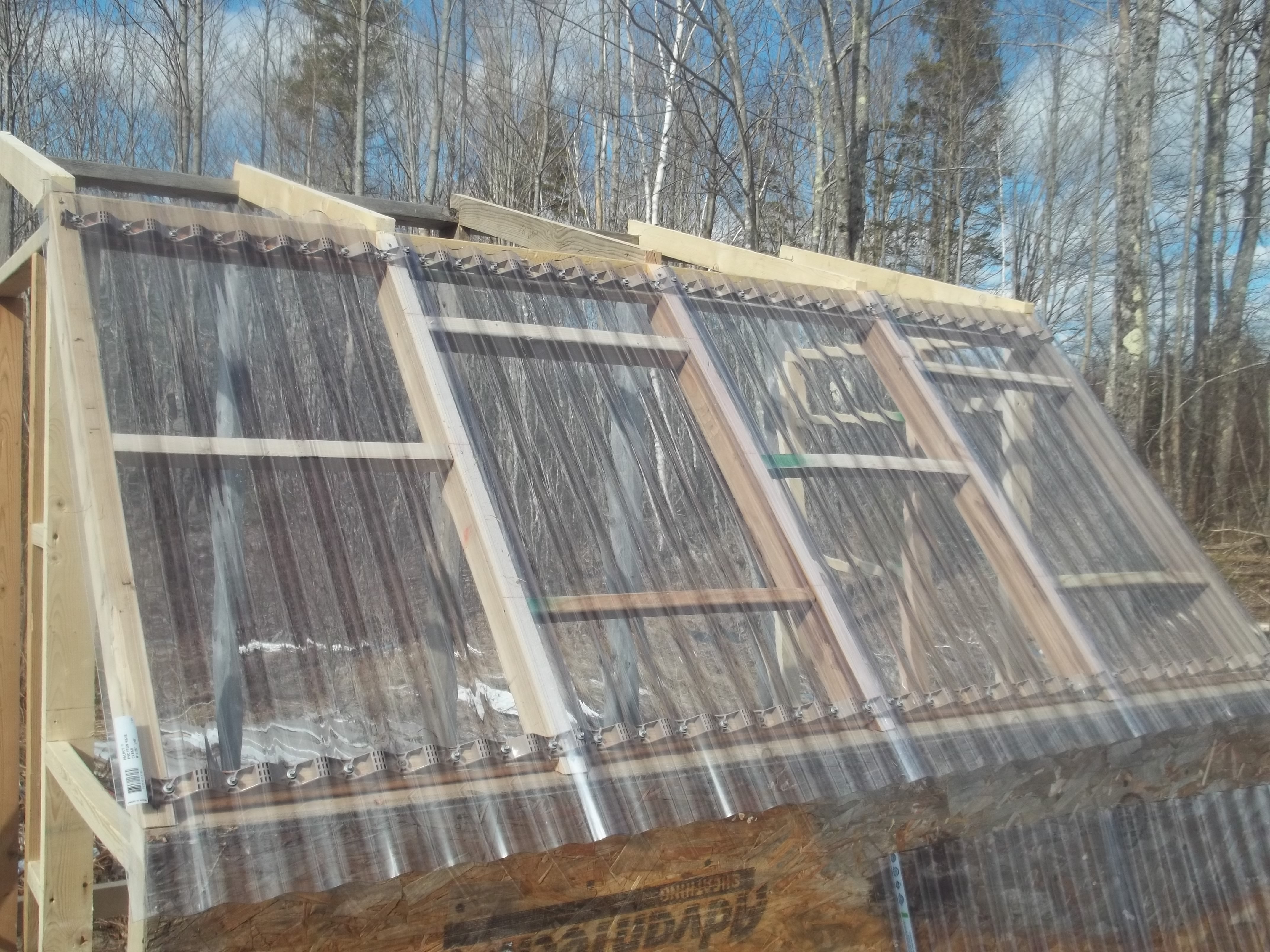 Ok, so...The lower sheeting is on, this is a very steep angle so there should never be any standing water or snow.  It faces almost straight south and made a big difference in temperature inside the open structure