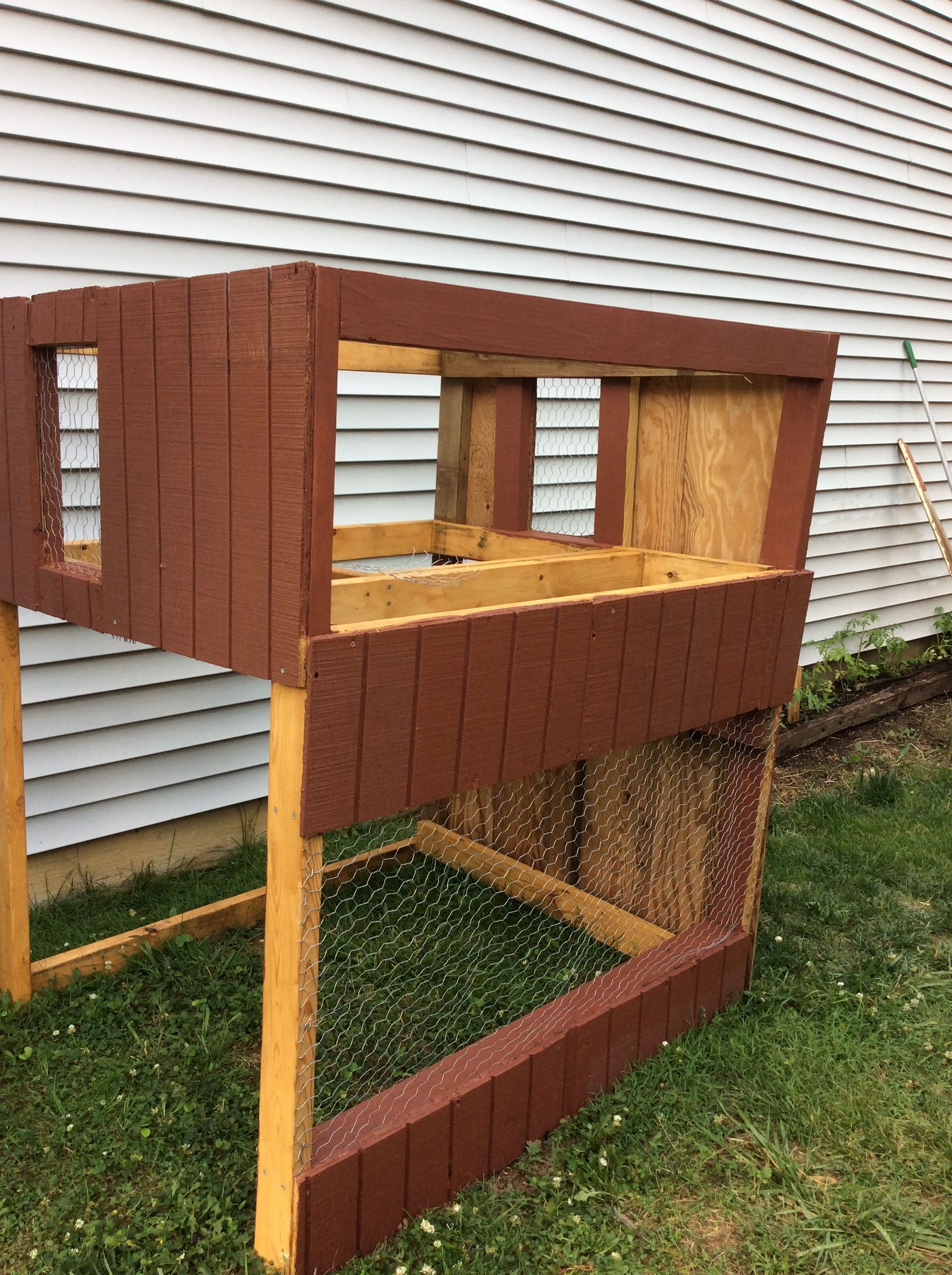 Once I had the frame and the plan for the nesting loft, I started adding windows and walls. I constructed two windows in the loft for cross ventilation in the hot months. I intend to install outside shutters on the windows to do the opposite during the cold months. I made the window on the bottom large so the hens can get some sunshine, if there comes a time when they're locked in their crib during the day. So far, they've been spoiled and allow to roam freely in their fenced-in backyard. 

I'm pretty sure I made a mistake with the kind of cage wire I chose. I bought it before I read-up thoroughly on predators and coop designs, so I didn't know about the durability of traditional chicken wire. Oh well! I guess it's a good thing that I used screws for just about all the construction, so when the wire rusts out I can easily replace it with a heavier gauge.

This is the point where I knew something was wrong with my skill saw; it started acting very angry whenever I used it to cut some of that re-purposed wanes coating. I began to dread using it, and would look for other things I could complete without. Pretty soon, though, it was impossible; I had to soothe my saw's temper and change the blade.

 In the mean time, I took my miter saw out of its box and put it to use. I couldn't cut the wanes coating with it, but I could cut frame pieces with it. Boy! talk about nervous; I was definitely afraid to engage the intensity of that blade. But, I did, and soon I was over my trepidation. It actually encouraged me to start on the roof.