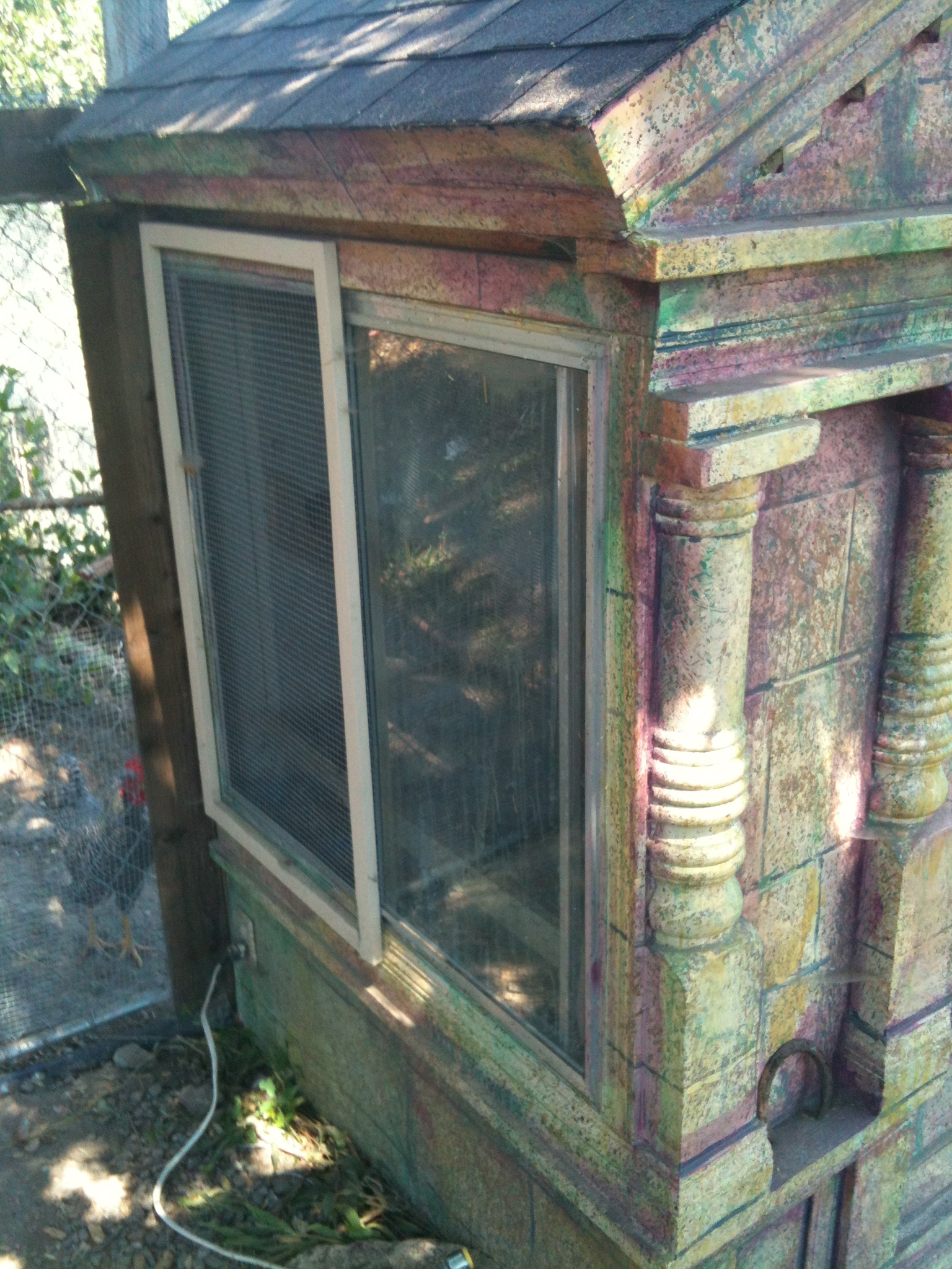 One of sides of the coop, showing the window in front of the roosts.