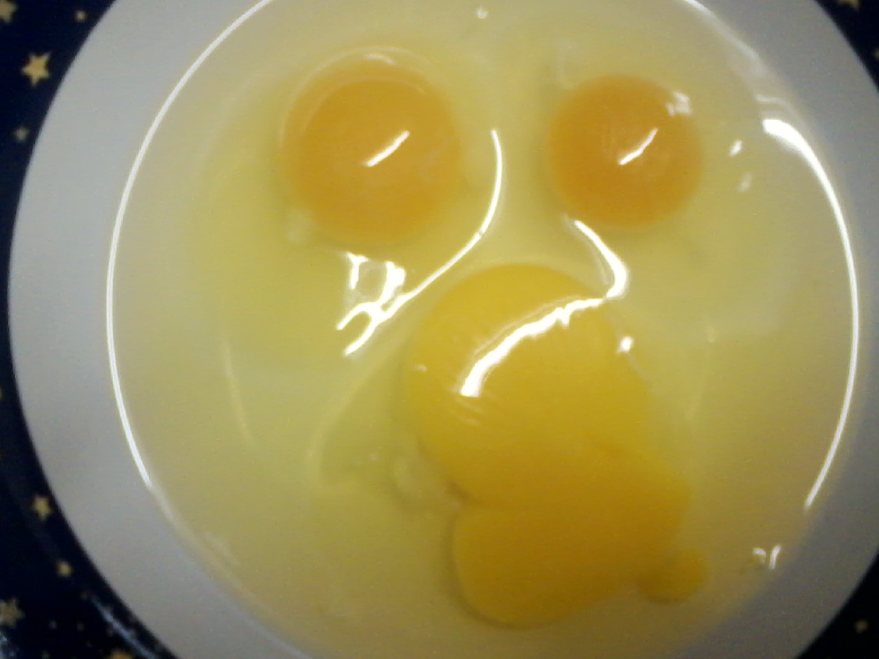 Our first two yolks compared to a commercial egg.