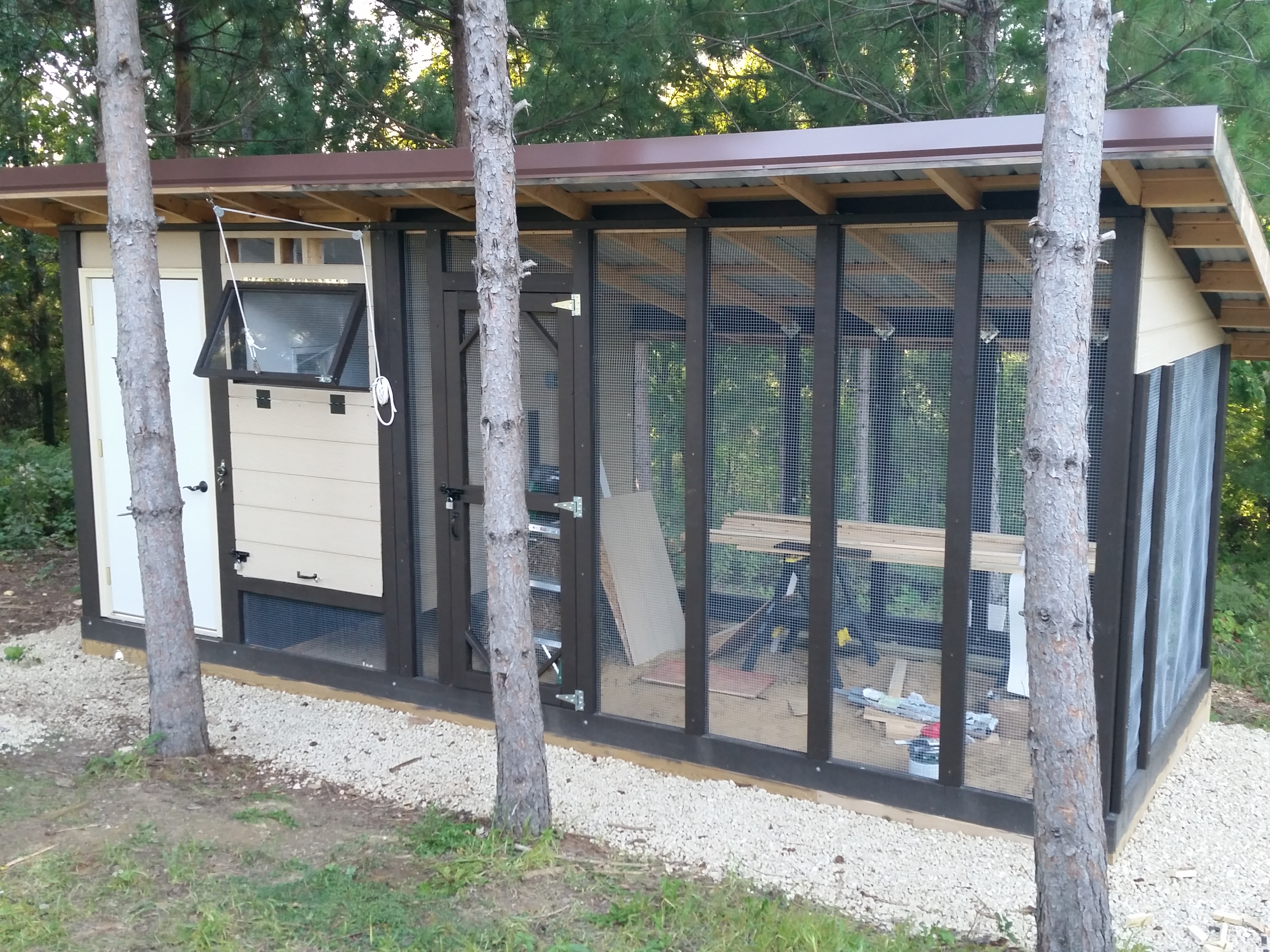 Our new 8X20 coop and run, almost finished, except for some paint, trim, and a ramp.The coop windows are hand made from 2x stock and some left over polycarbonate material from an old tear down years ago.  The coop doors also open up like the windows, so my pulley system works for both.  When cleaning the coop, we just move the fastener from the window down to the door and hoist away.  The vent openings above are covered with hardware cloth on the inside.  Still haven't figured what we want to place outside yet.