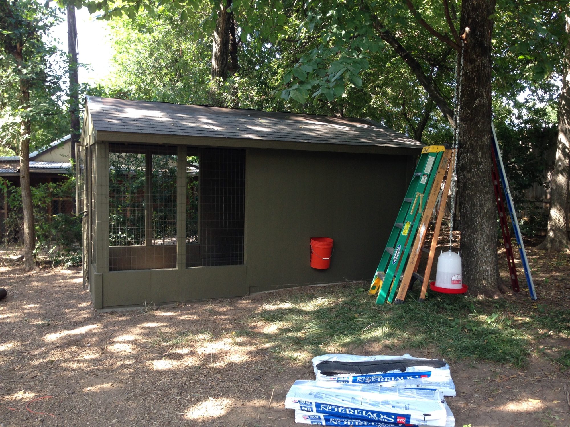 Painted and Shingled!  The orange bucket is where the Automatic Chicken Door will be installed! 7/22/15