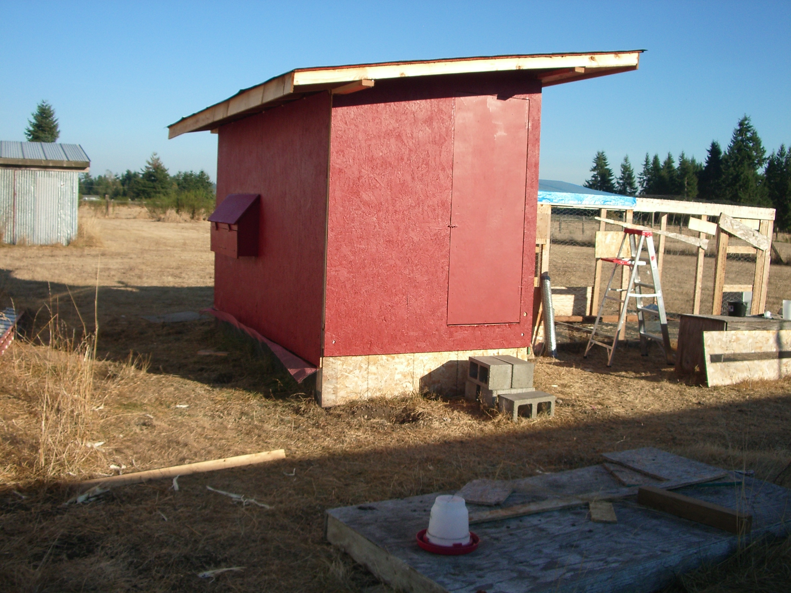 Painted barn red, now waiting for the trim work to begin.