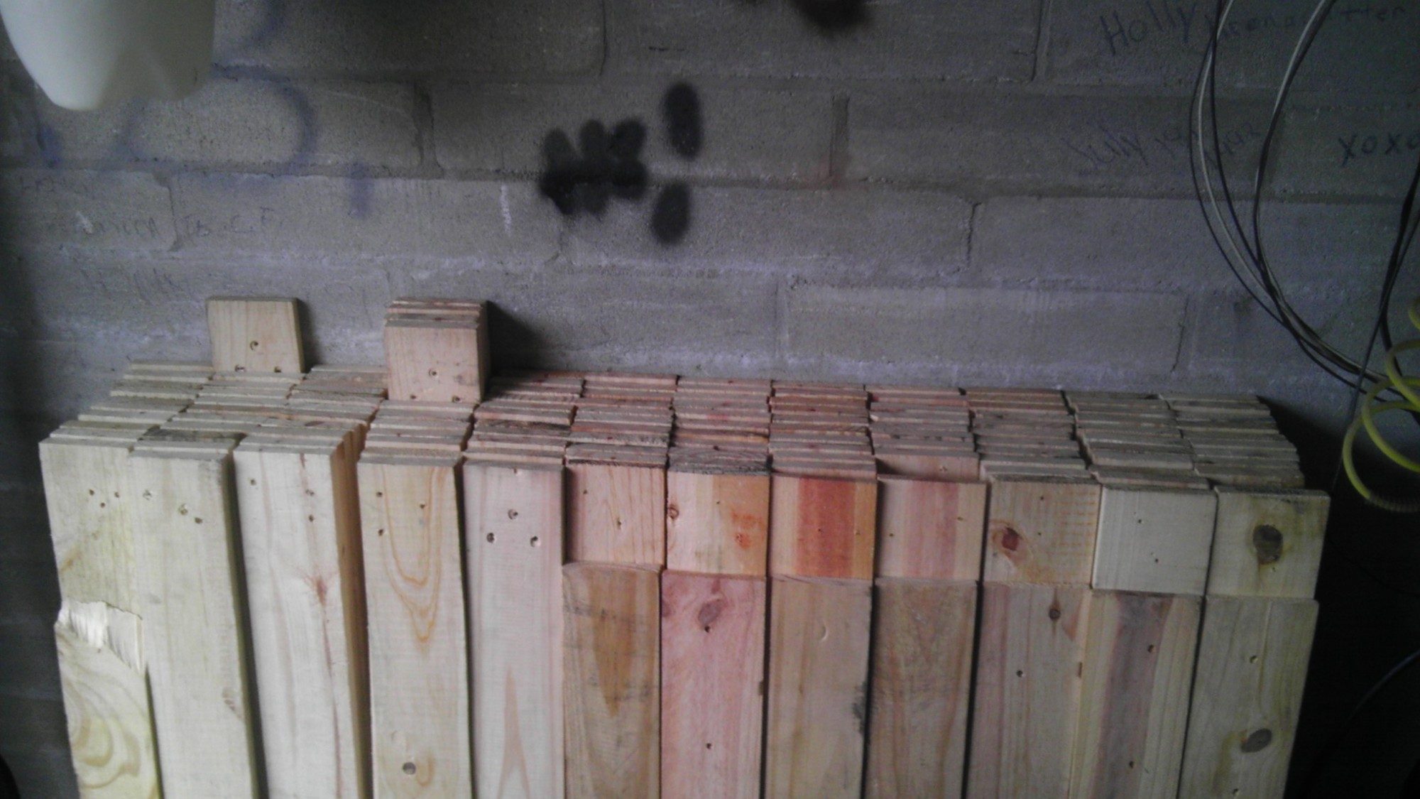 Pallet boards with all the nails removed and stacked in the garage waiting to be used.  There are 132 here and I just added another 100.  I saved around $200.