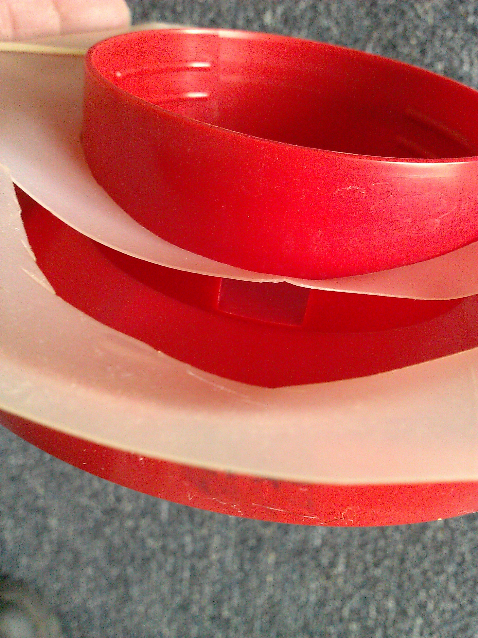 Place plastic circle on waterer base and align the slot you cut in the plastic circle with the base's water drain.