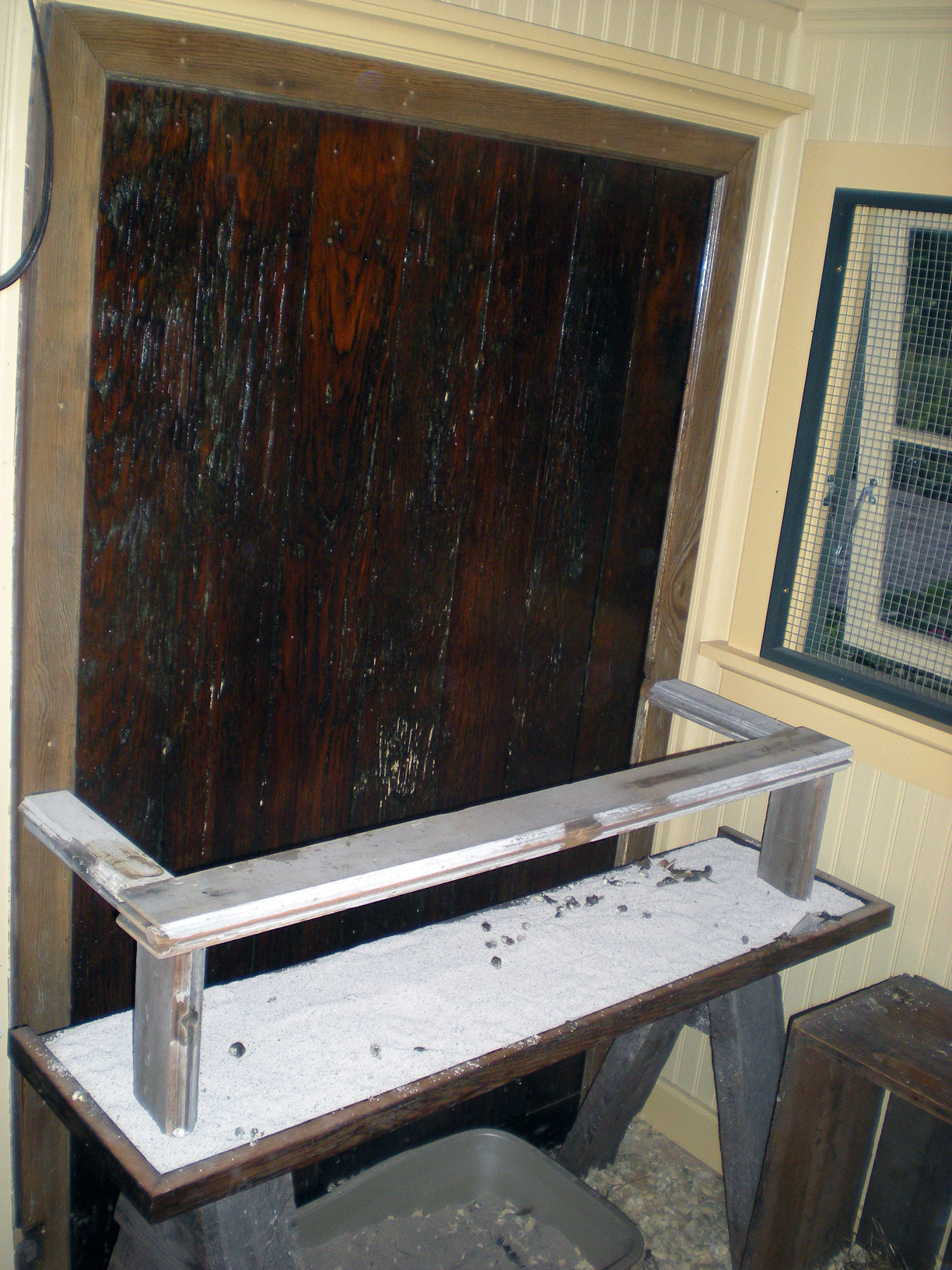 Poop board and roosting bar area all from reclaimed wood.