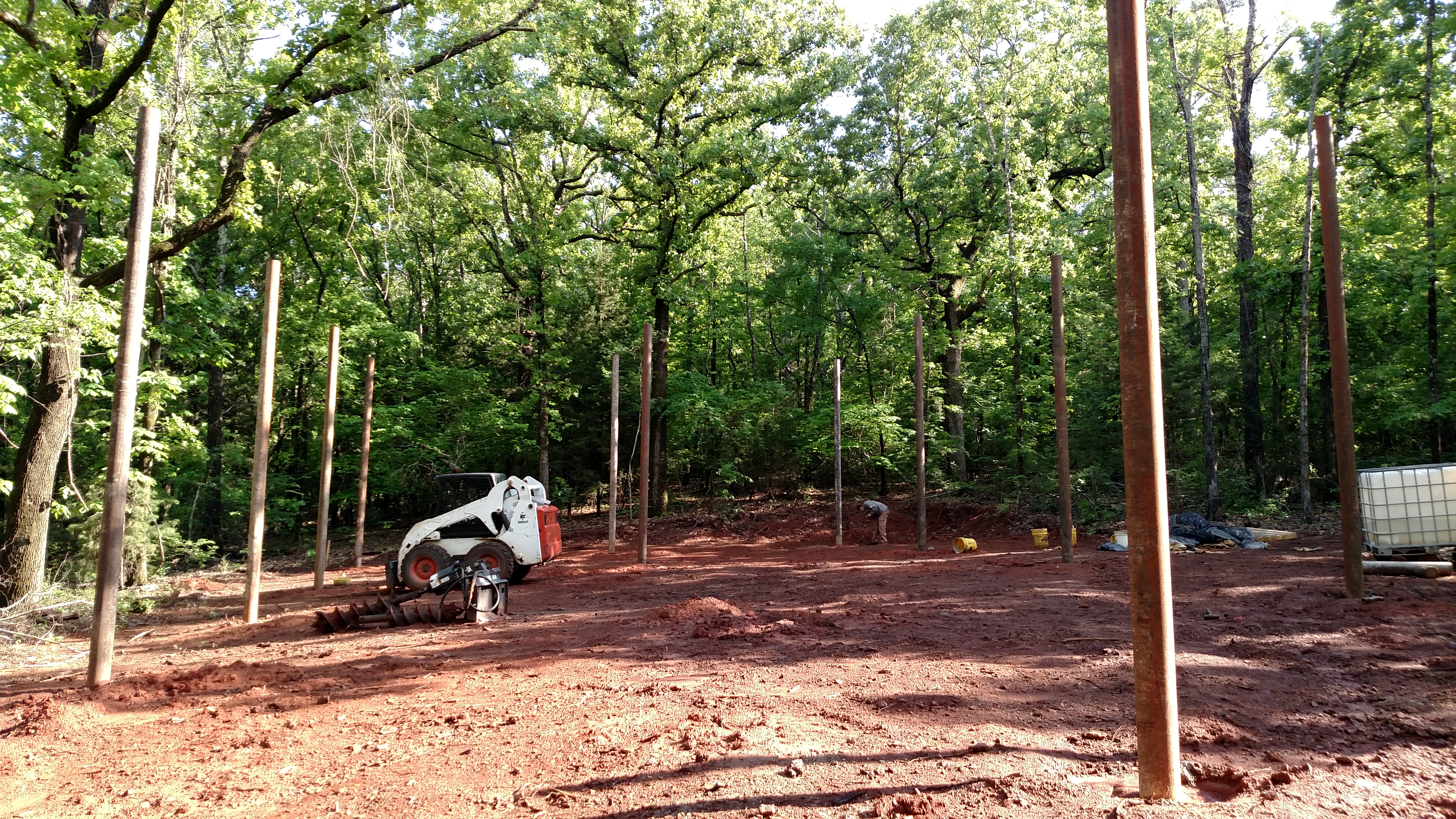Posts set for main framing.  6" round pipe.  Unusual, I know.  But it is my brothers.  Will be interesting to watch this come together.  80X40 with loft, open/vaulted ceilings, steel frame, steel roof, steel siding, walk out, storm shelter.....