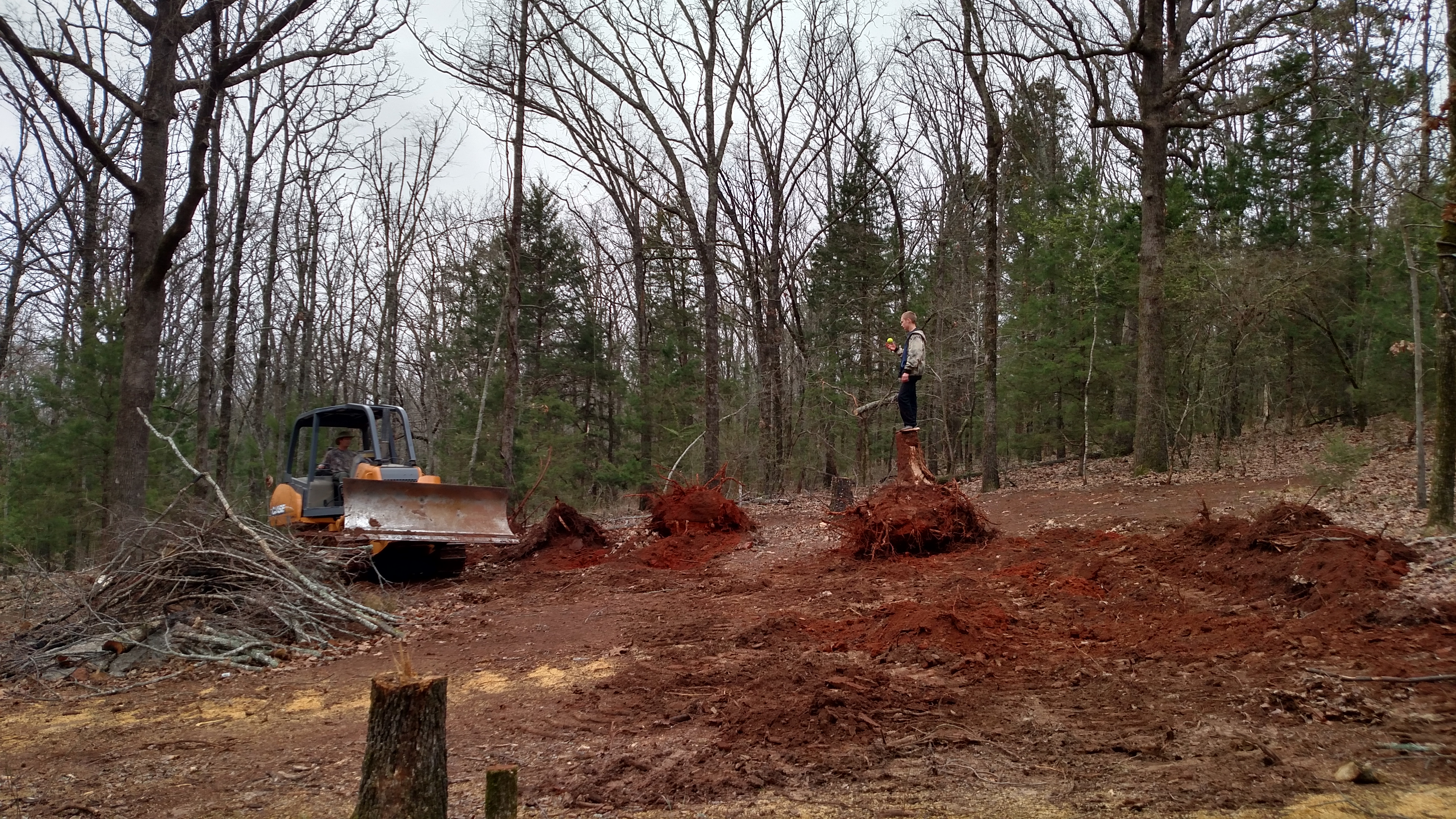 Pushing stumps and leveling pad site.  Already cleared the beginning of a road and clearing to pad site.