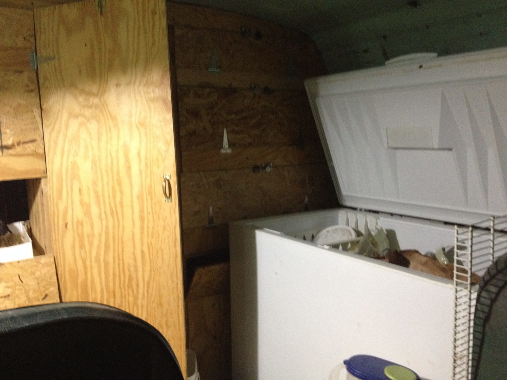 Put a non-working (free) deep freeze in front of bus to store feed.
