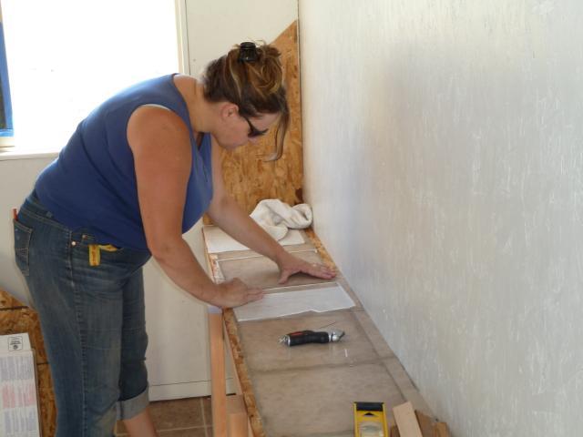 Putting linoleum tiles down under the nesting boxes so they don't rot out.  Keeps things a little cleaner.