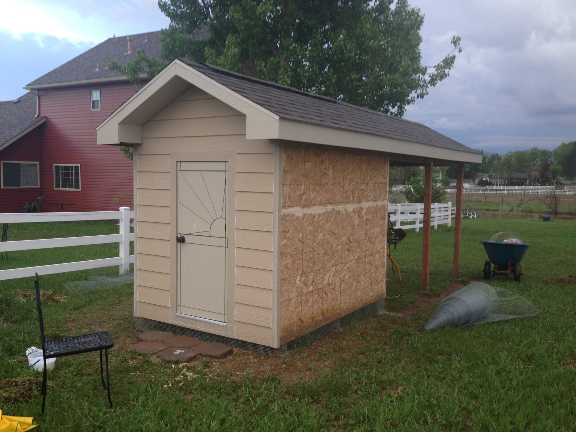 Putting the siding on was a lot easier than I thought.  You can see our house behind the coop... all of our out-buildings match the house (the barn, shop, shed, etc).  So we wanted to match the coop to the house as well- hence the over-the-top design.