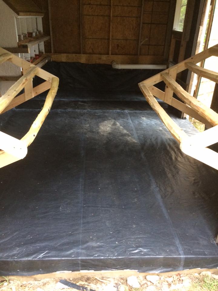 Recycled a vinyl billboard to cover the wood floor. Should work better than paint and its free! For now we are covering it with pine shavings but the plan is to switch to sand by this spring.