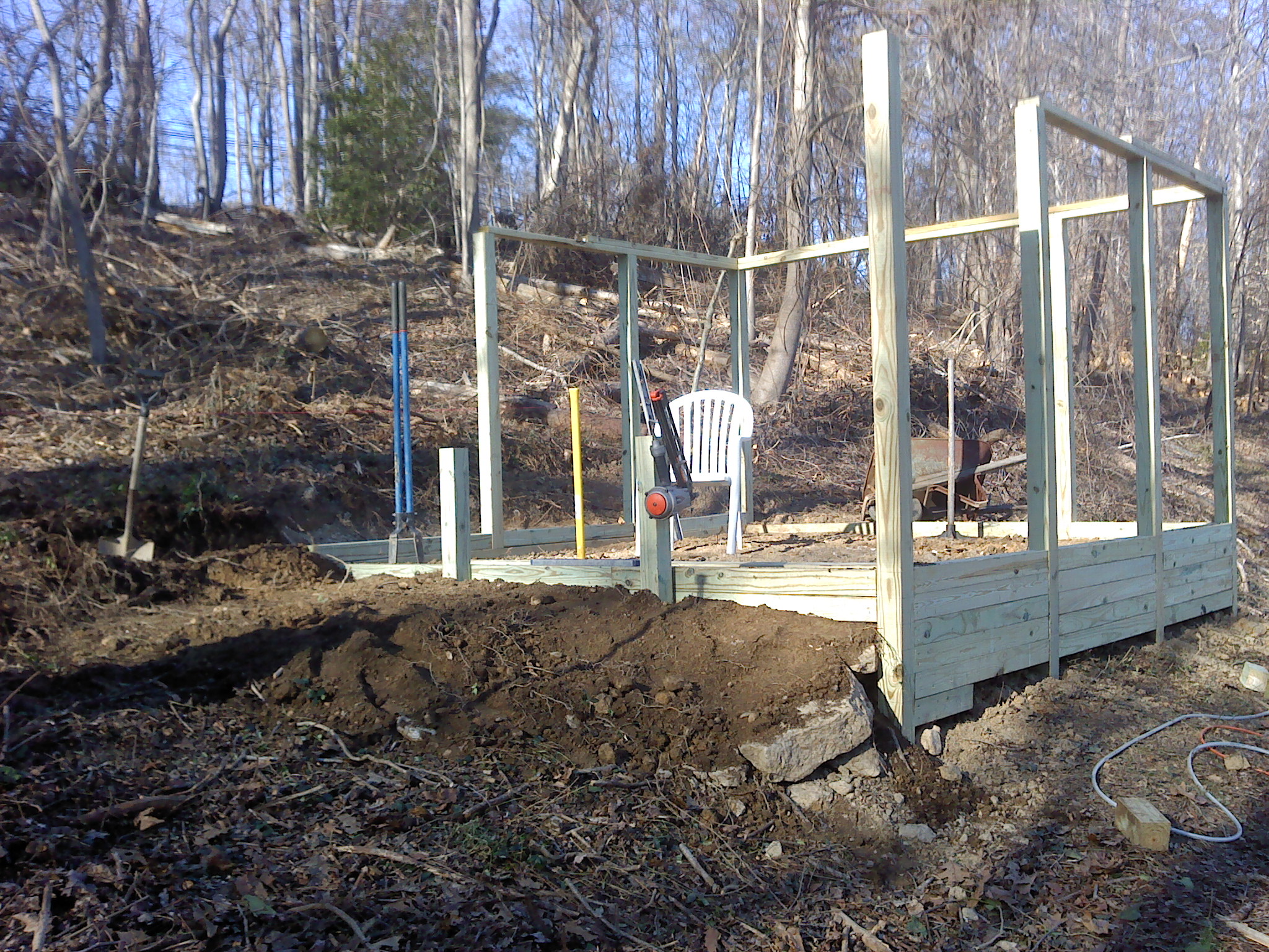 Retaining walls are in, pen is level with dirt. Hardware cloth needs to be installed on outside perimeter and back filled at a later date.