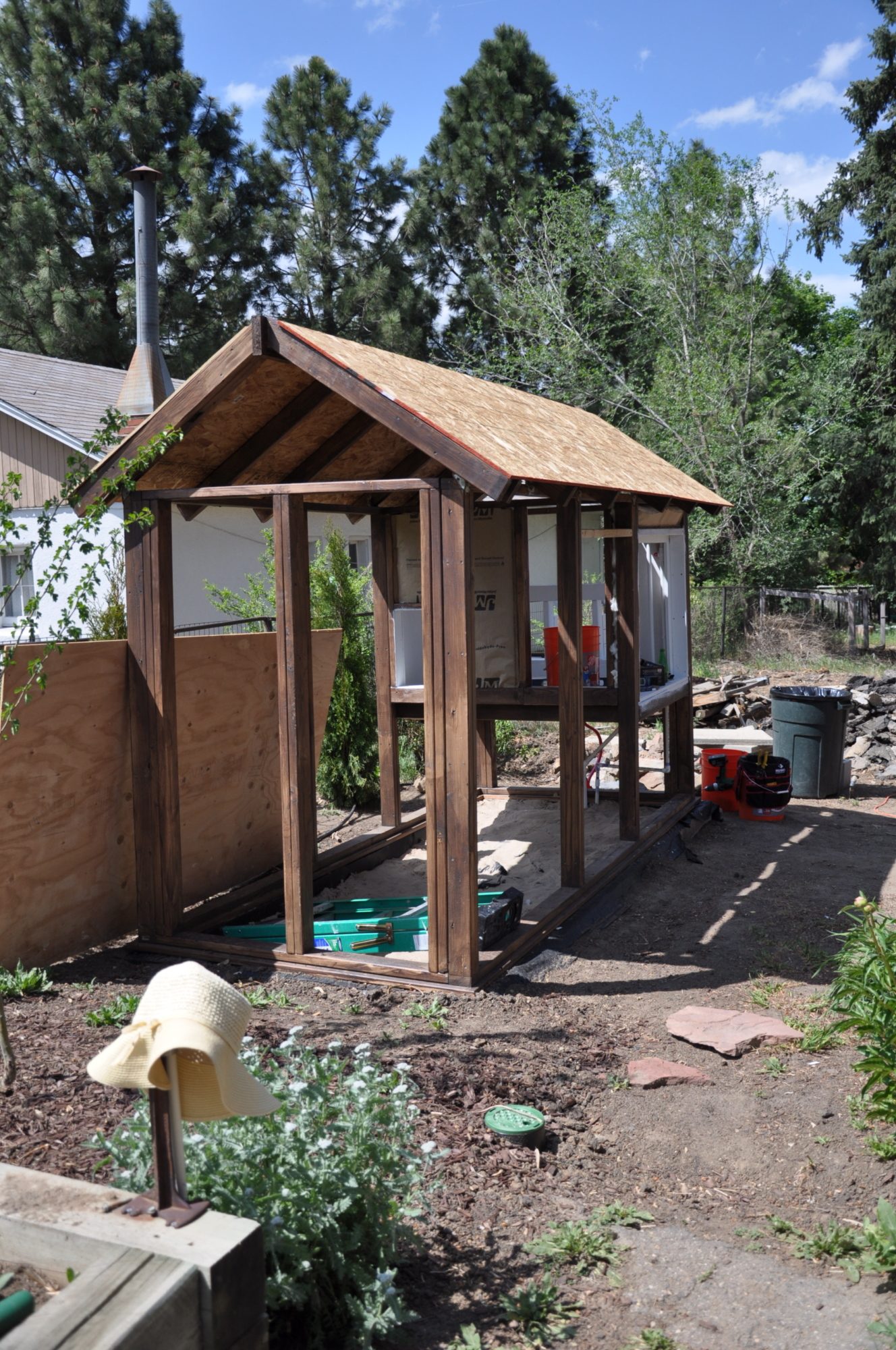 Roof sheathing installed, and all framing members have been stained