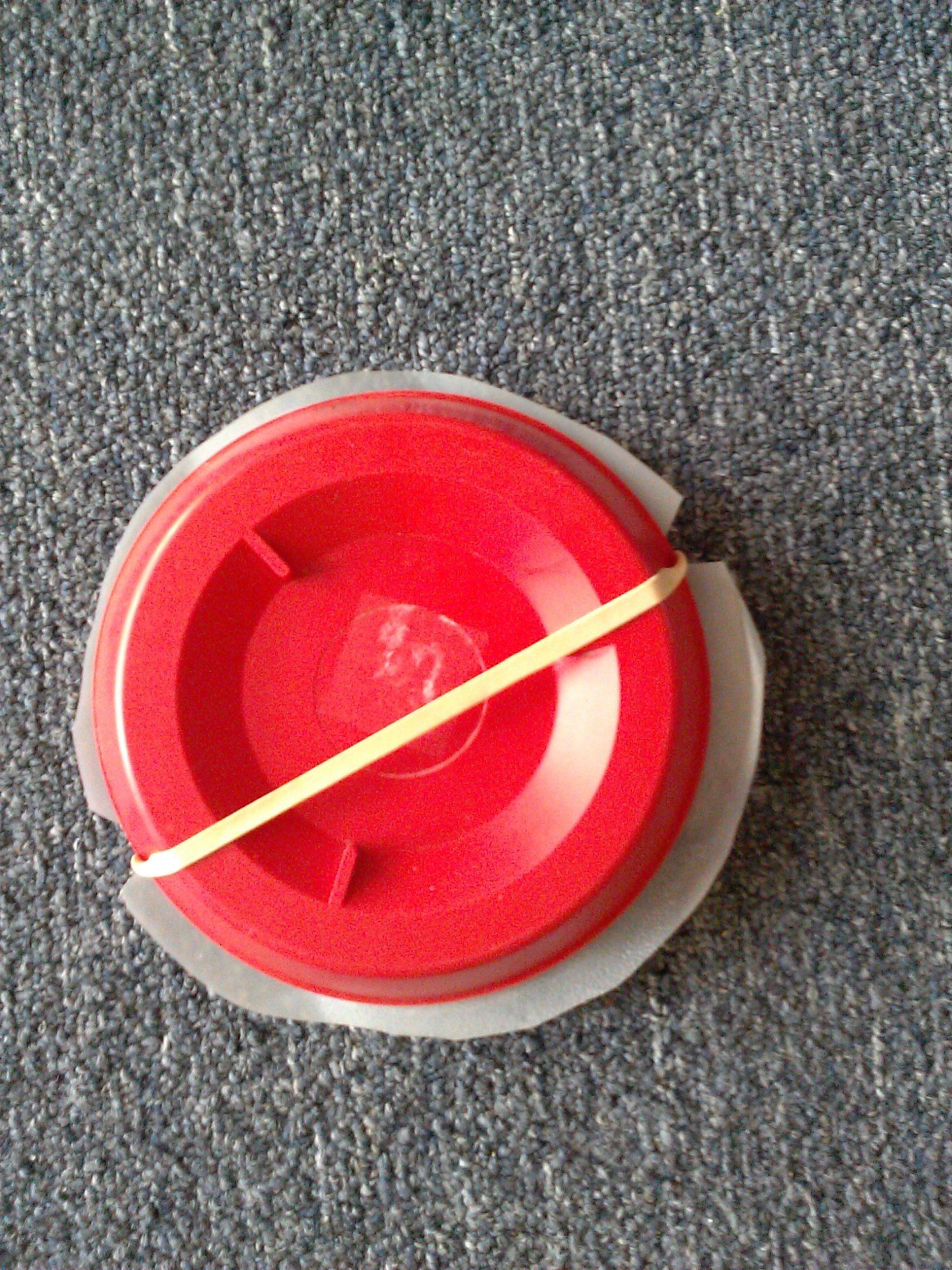 Rubber band is fitted into notches of plastic circle and across the bottom of the base.
Fill water bottle, screw on your drown-proof base, and hang at appropriate height for your chicks.
My chicks didn't have any trouble finding the water slot after they were shown, and this waterer was adequate for 12 chicks for several weeks.